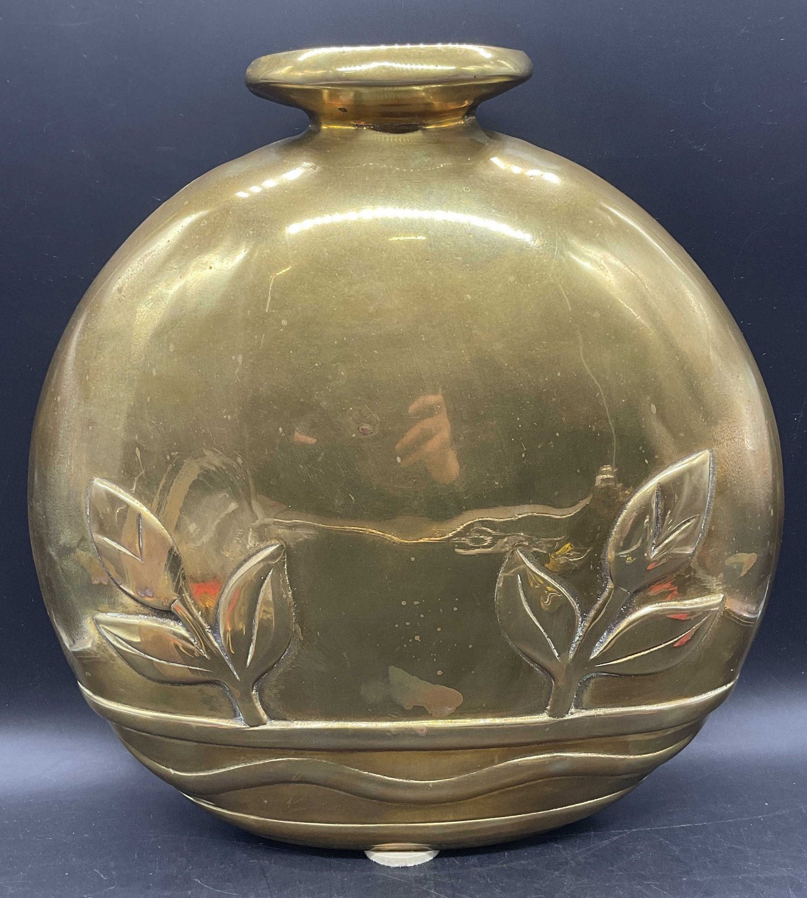 1980 Dolbi Cashier Brass Art Deco Vase: 1980 Dolbi Cashier brass vase. Flask shaped with raised art deco style foliate motif. Measures approx. 13 x 3.75 x 14.5 inches. Vase has significant weight. Wear including patina and scratching.