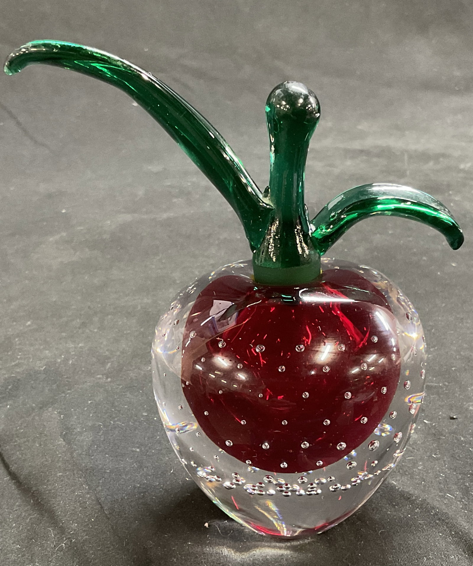 VTG Glass Apple Paperweight Perfume Bottle: Vintage Glass Apple Paperweight Perfume Bottle. Clear Glass with Red Sphere and Controlled Bubbles. Green Glass Removable Stem. Light Scratching. Measures app 5in H x 1in Base. Vintage Paperweight, Vi
