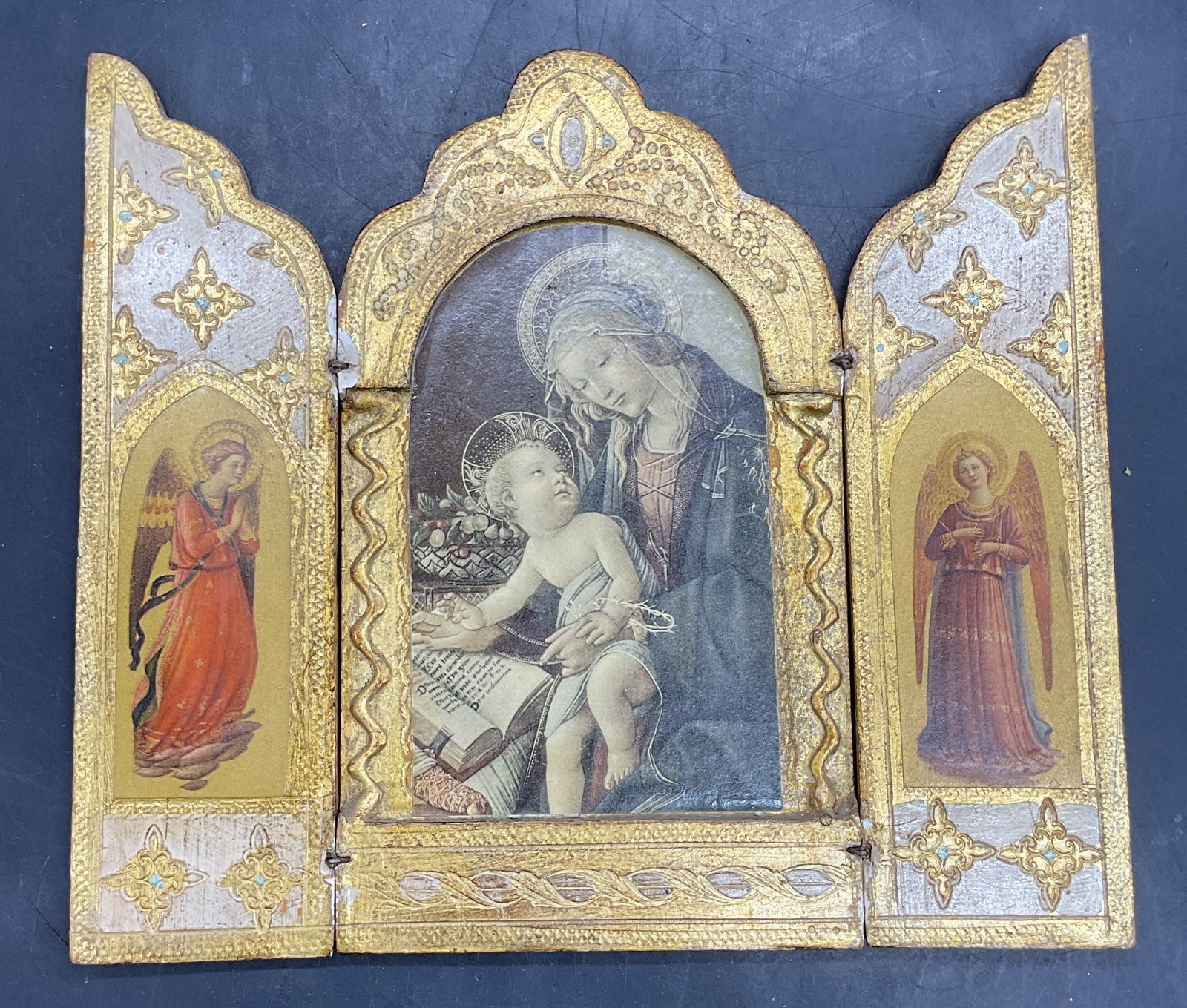 Vintage Gilt Wood Italian Religious Triptych: Vintage Italian religious triptych. Painted Ang lit wood panels with religious lithograph prints. Central Madonna and child with angels on sides. Total dimensions approx 7 x 8 inches. Some chips, scra