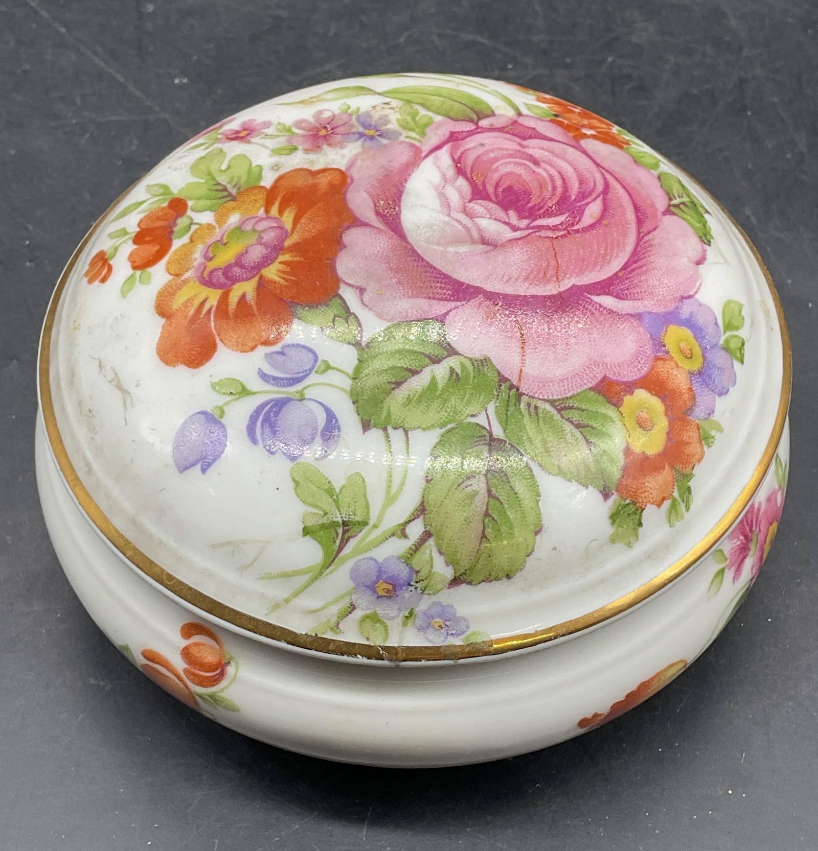 HT Limoges Porcelain Floral Trinket Box France: Vintage HT Limoges porcelain trinket box with hand painted and gilt floral design. Made in France. Measures approx. 4 x 2 inches. Some scratching and loss to paint. Ht trinket box, Limoges trinket box