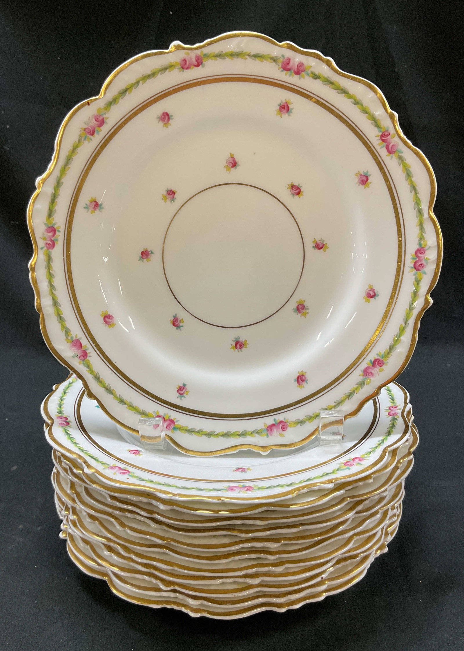 Set 12 Cauldon Porcelain Floral Plates England: Set of 12 Cauldon porcelain floral plates. Marked on underside, reads Cauldon England. Round plates. Gilt scalloped edge. Floral and leaf motifs in varying colors. Measures approx 9 inches in diameter