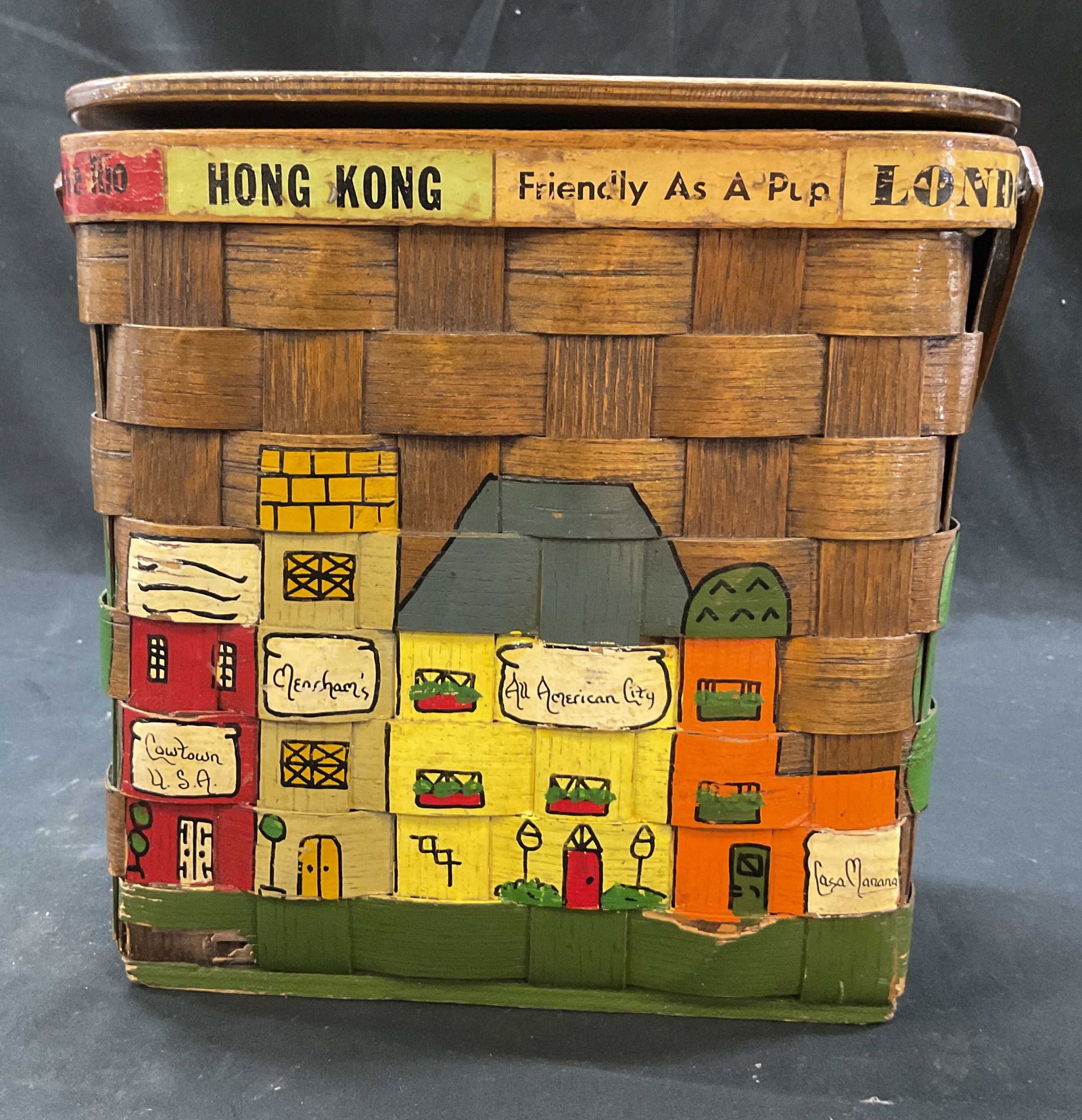 Caro Nan Hand Painted Woven Basket Purse: Caro Nan hand painted wood woven basket purse. Marked Caro Nan. Hand painted scene of buildings with different names on them, some include Cowtown USA, All American City, and more. Travel theme with p