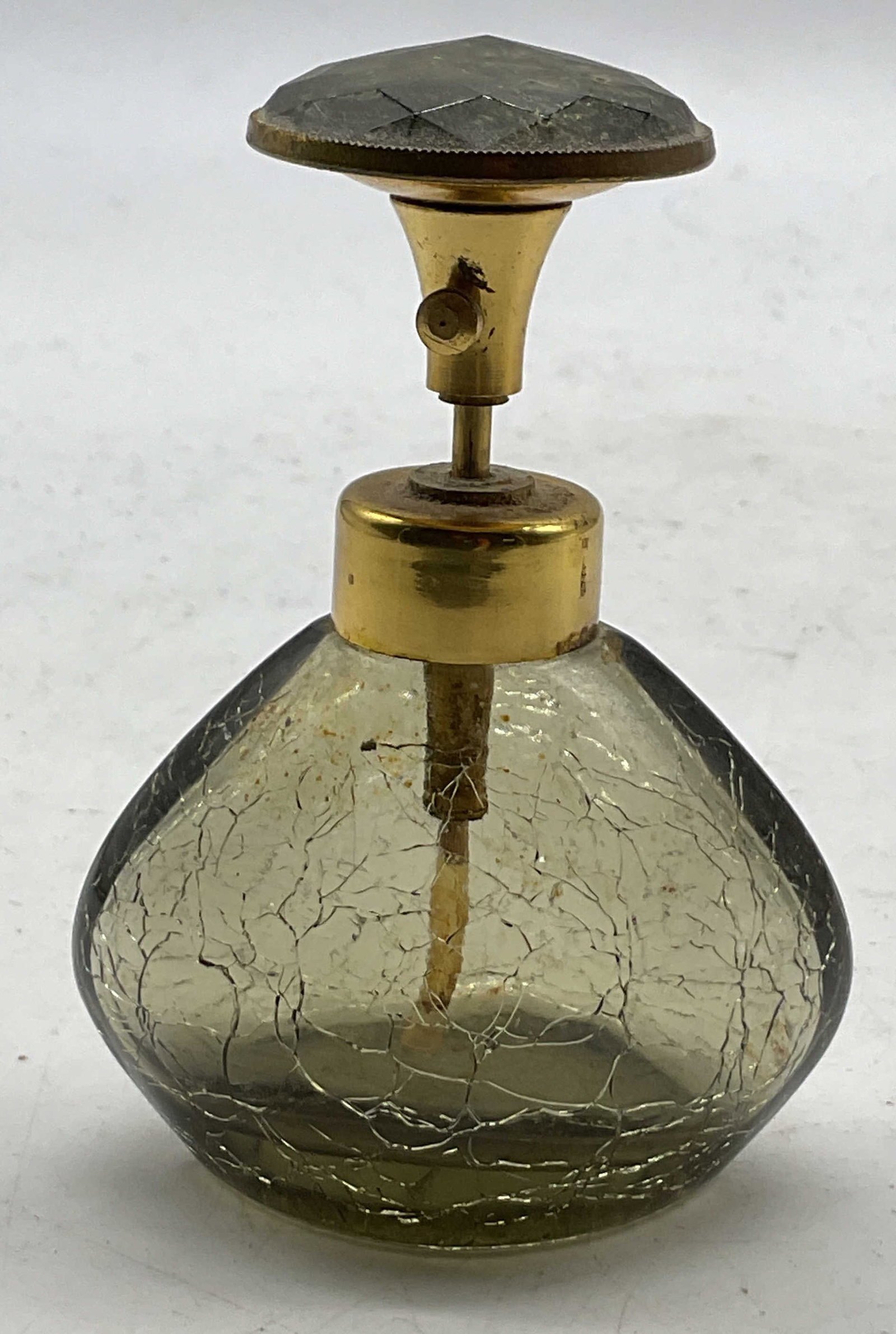Irice Glass Perfume Bottle: Irice glass perfume bottle. Marked Irice on underside. Crackle like pattern. Decorative finial. Gold toned accents. Darkened tint. Measures ht approx 3.5 inches diam approx 2.5 inches. Some scratching