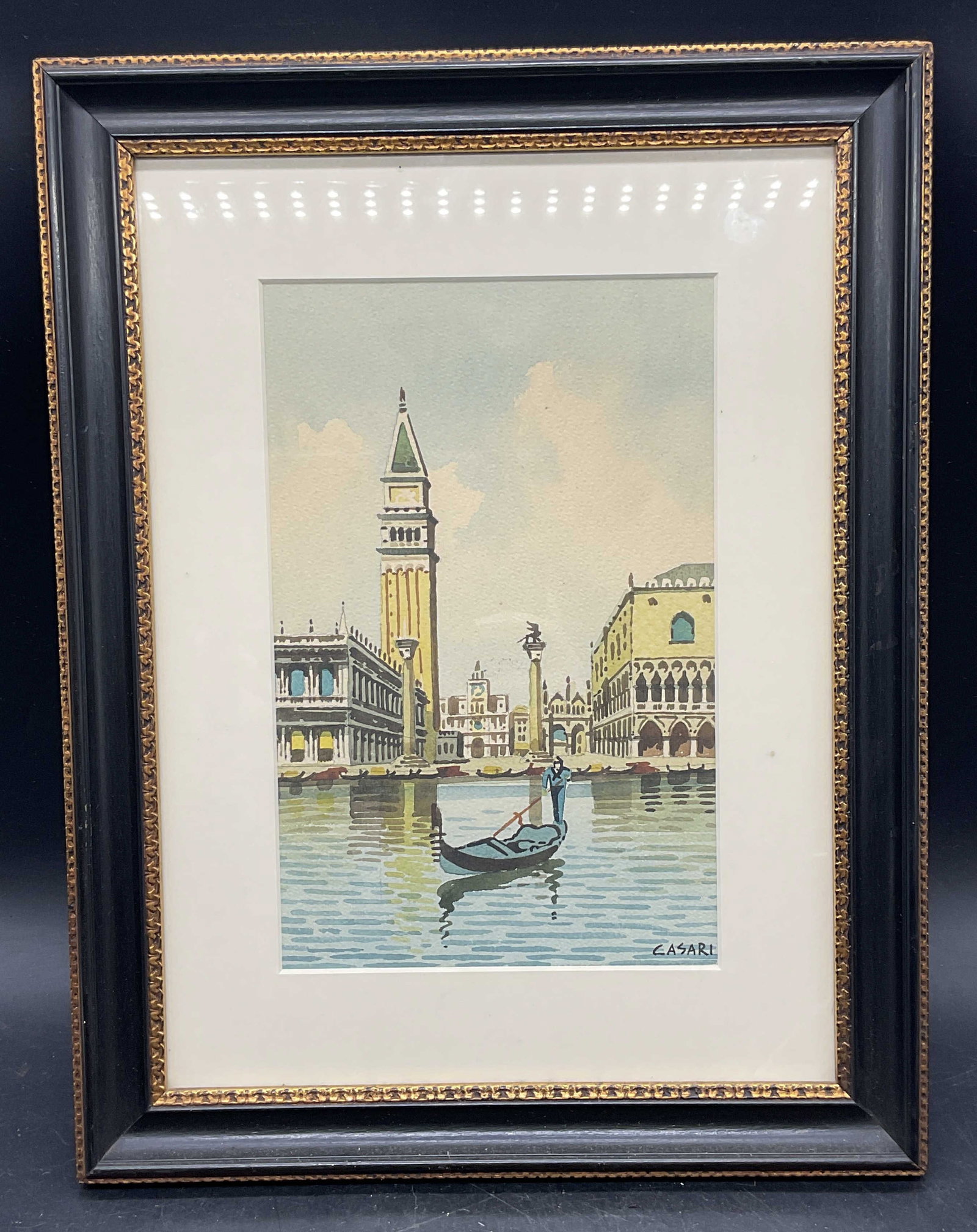 Framed Sgn Casari Venice Watercolor Painting: Framed and matted watercolor painting. Signed lower right, Casari. Italian scene, Venice with boat and buildings. Black and gilt wood frame. Not examined out of frame. Frame measures approx. 15.5 x
