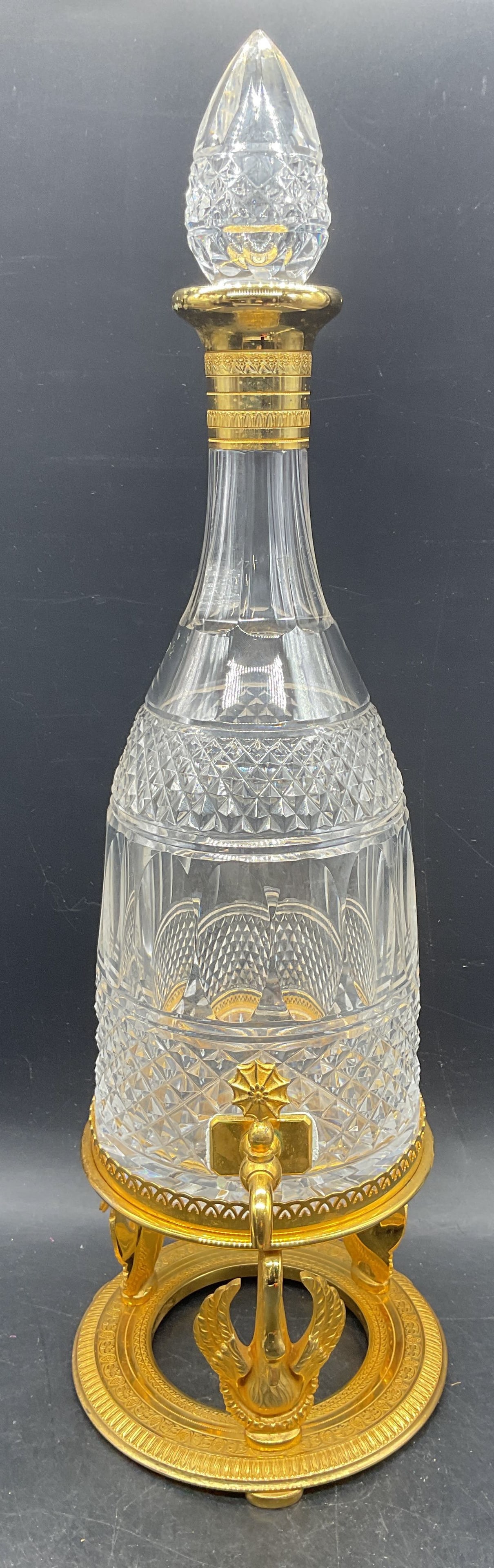 Crystal Decanter Dispenser & Ornate Stand France: Vintage cut Crystal decanter with gold plated rim, diamond and oval paneled design. Dispenser at base. Gold plated ornate stand with swan motifs. Made in France. Decanter measures approx. 5 x 13
