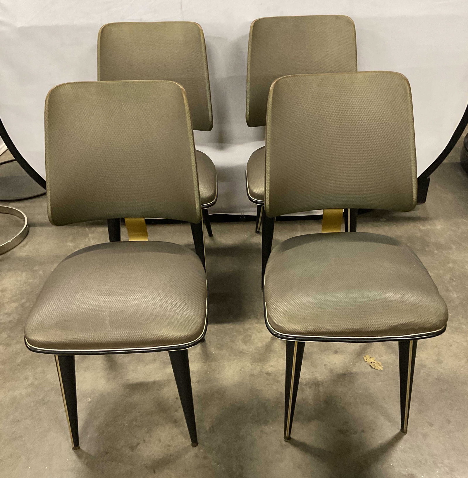 Set 4 Umberto Mascagni Dining Chairs Italy 1950s: Set of 4 vintage Umberto Mascagni for Harrods dining chairs. Grey leatherette seats with black legs and gold tone accents. Made in Italy circ 1950s. Measures approx. 17.5 x 17 x 35.75 inches. Wear inc