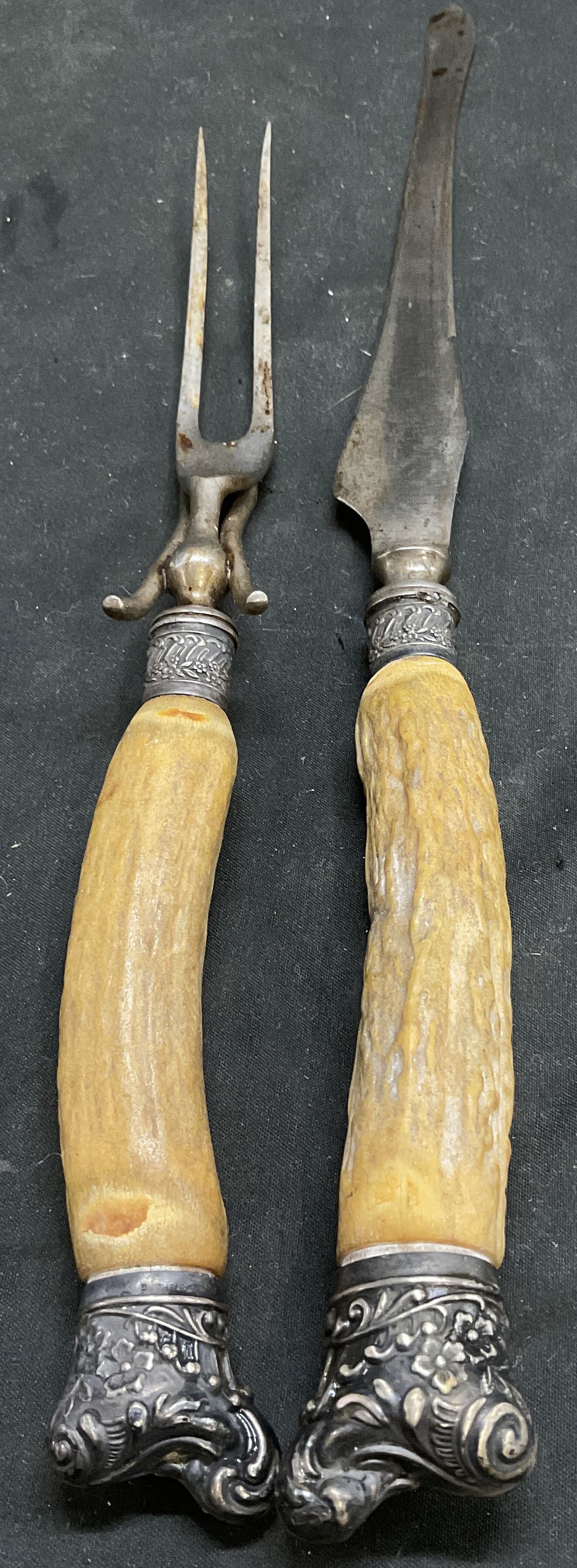 Lt2 ANTQ Stag Horn w/ Sterling Collar Carving Set: 2 Antique Stag Horn Handle With Sterling Silver Collars Carving Set. Silver-Plated Blades and Ends. Includes A Carving Fork and Knife. Scratching, Rusting, and Tarnishing Present. Measures app 15.25in