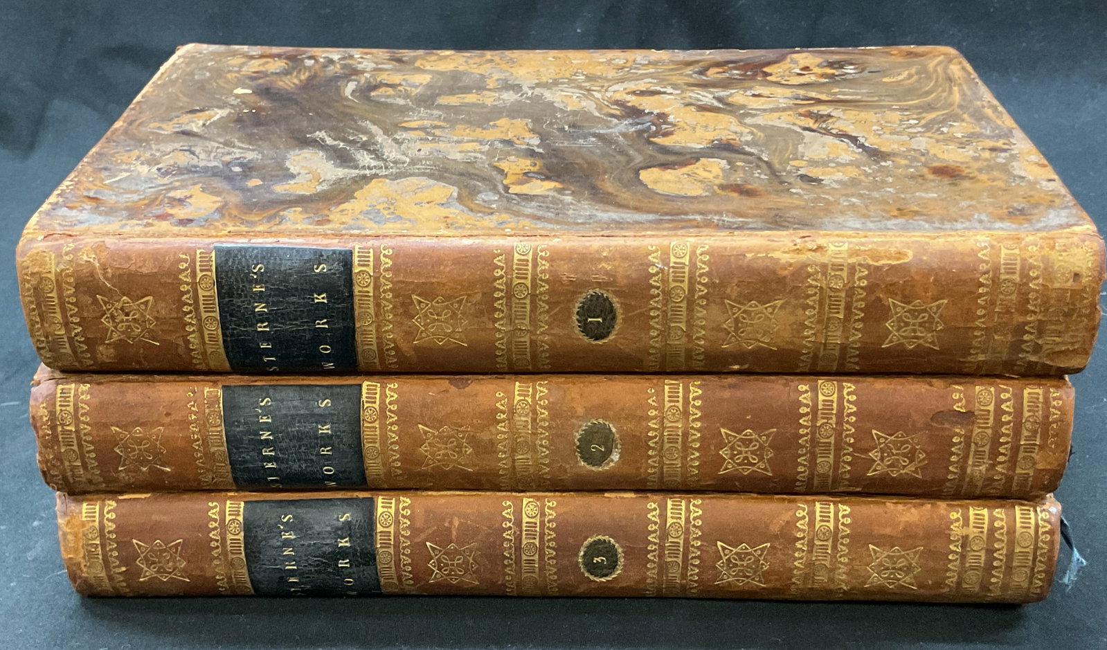 Set 3 1808 Works Of Laurence Sterne Illus Books+: The Works Of Laurence Sterne volume 1-3. Written by himself. Dated 1808. Contains some illustrations. Hard cover leather bound with embossed gilt trim and marble design. Measures approx 5.5 x 8.5 inch