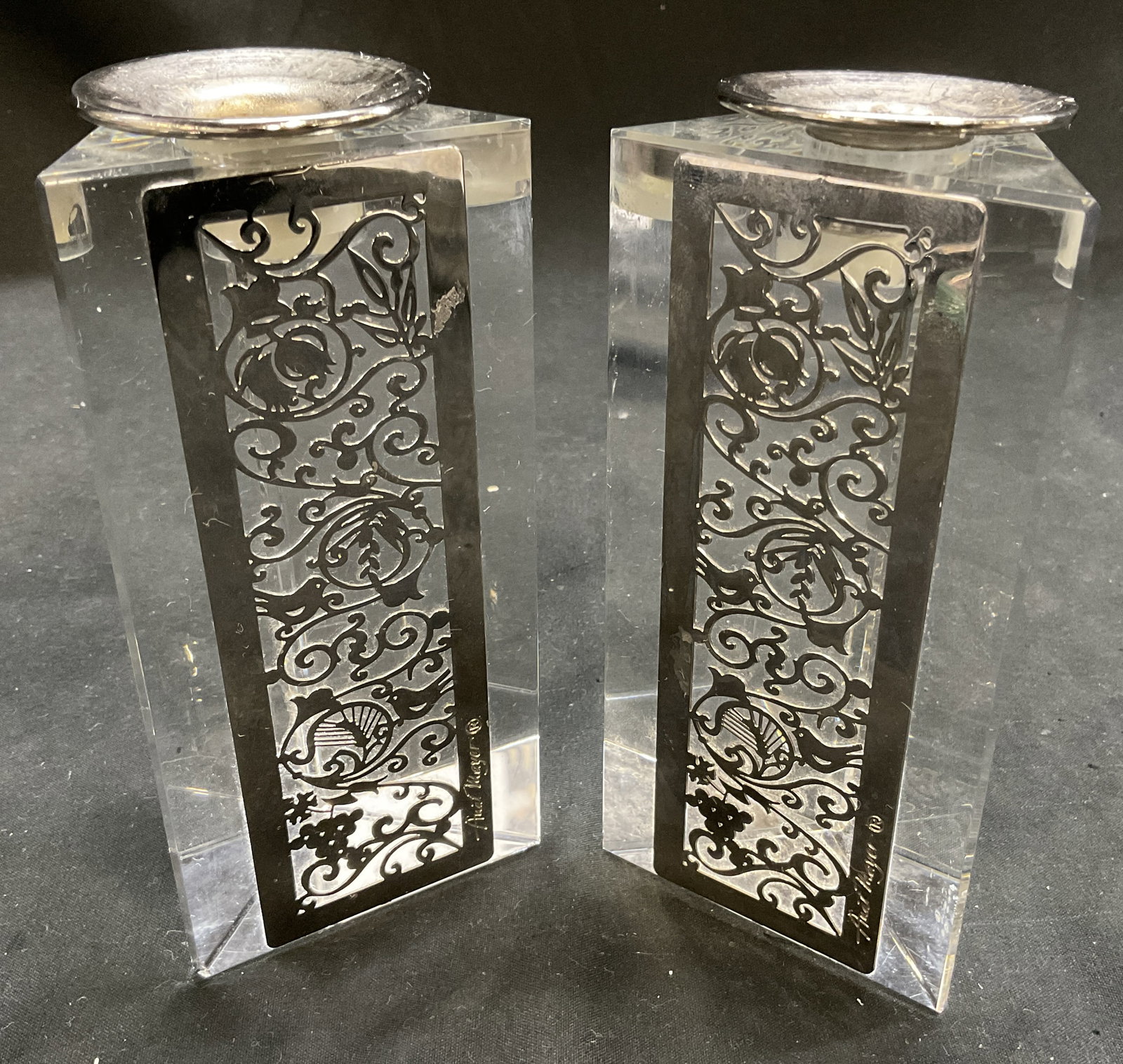 Lt2 SGND Anat Mayer Metal&Crystal Candlestick Hld+: 2 Signed Anat Mayer Candlestick Holders. Triangular Crystal With Silver-Toned Metal Filigree Inlay. Bird and Floral Motifs. One Candle Holder Top Needs Adjustment. Measures app 5.5in H x 2.5in Wide. C