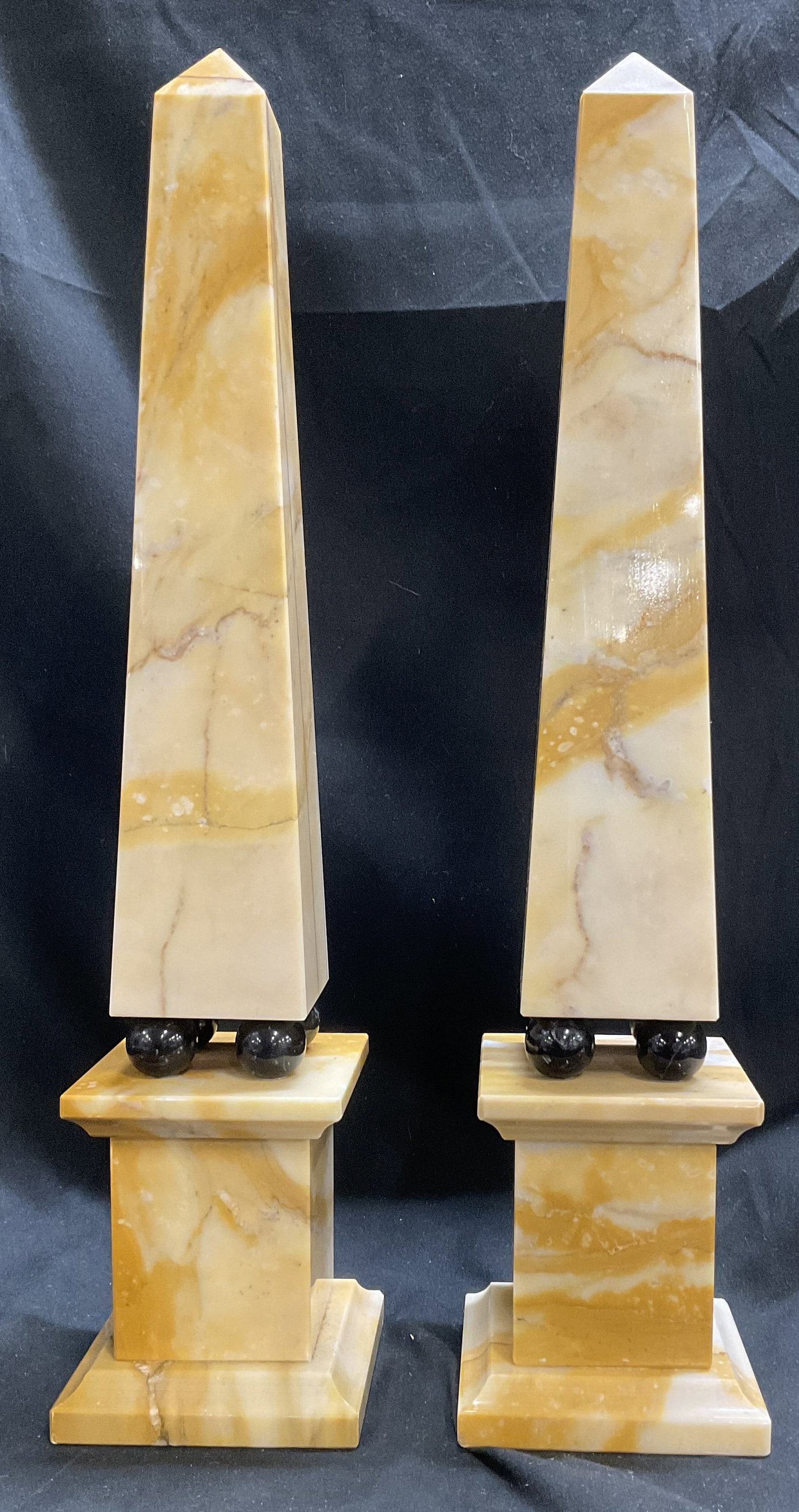 St2 16.5in Sienna Marble Obelisks ITALY: Set of 2 Sienna Marble Obelisks. Rests on Four Black Glass Marble Balls. Made in Italy. Some Cracking. Measures app 16.5in H x 3.75in W. Marble Obelisks, Italy, Italian Marble, Stone, Sienna, Yellow S