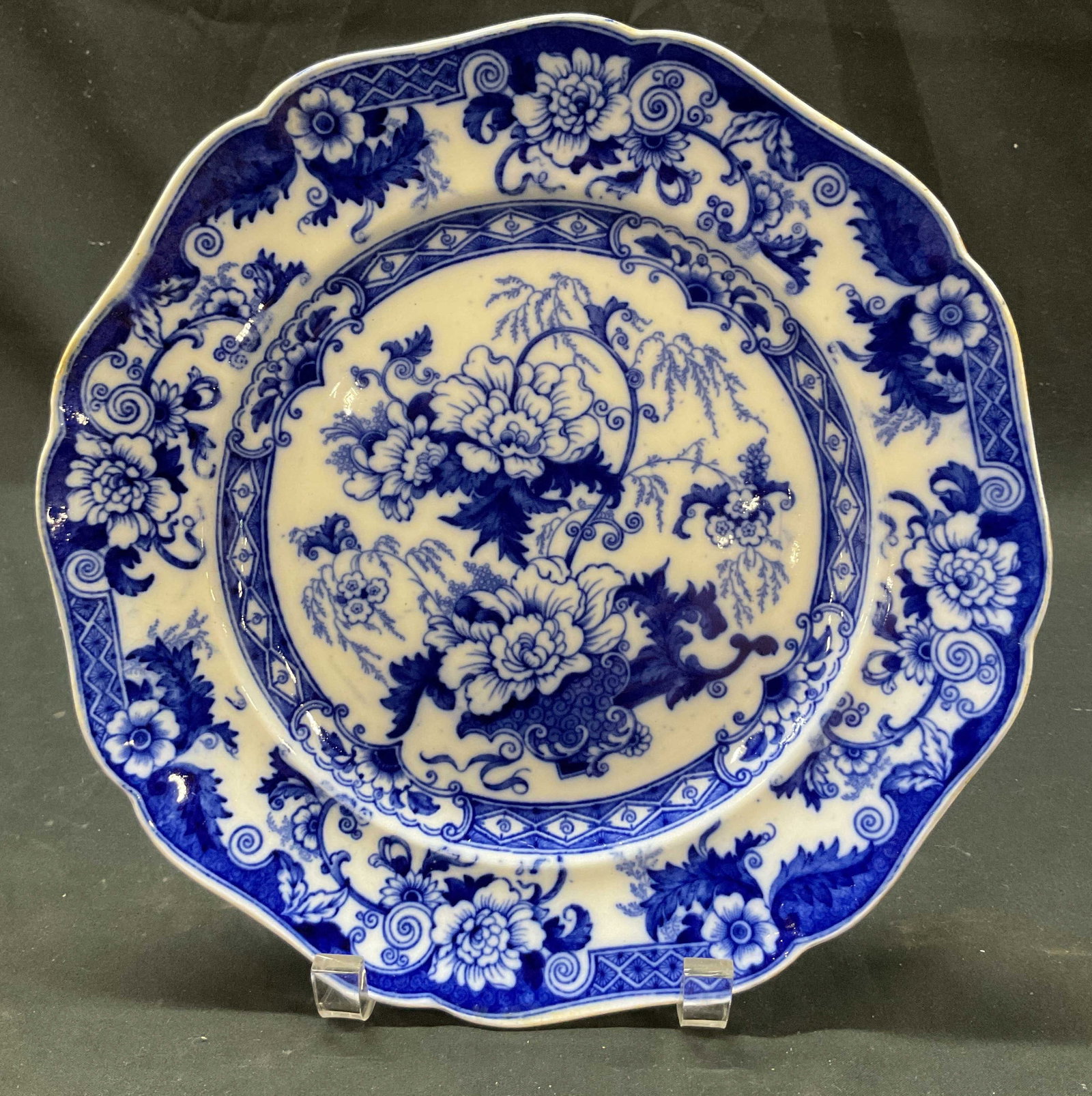 Bentick Cauldon Stoneware Plate England: Bentick Cauldon blue and white stoneware plate. Marked on underside, reads Stoneware Bentick Cauldon England. Round scalloped plate. Blue and white floral and geometric motifs. Measures approx 10 inch