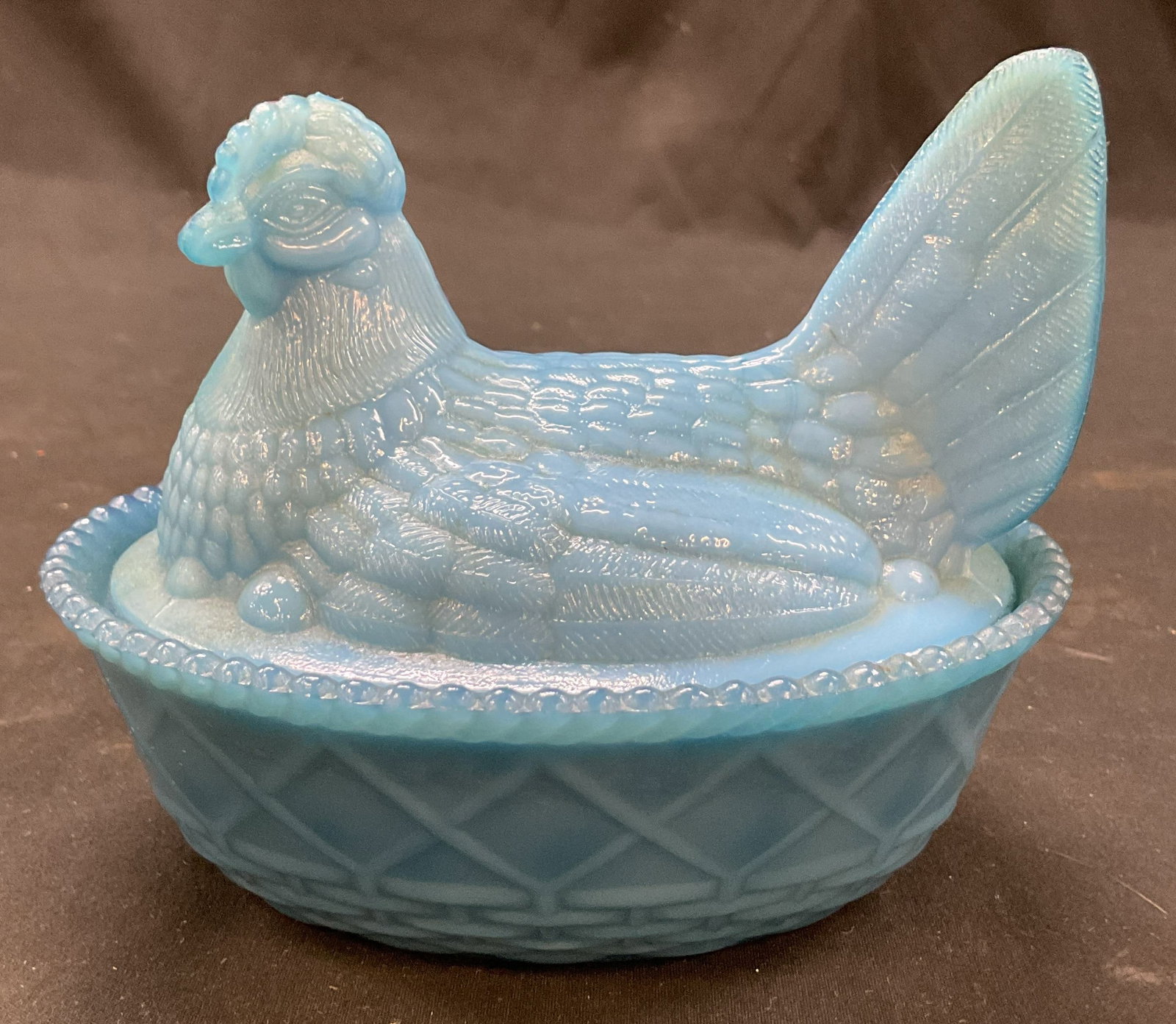 Vintage Blue Glass Hen Covered Candy Dish: Vintage blue glass hen covered candy dish. Hen shaped lid with detailed features. Oval shaped dish with scalloped edge. Basket weave design. Textured surface. Measures ht approx 4.5 inches diam approx