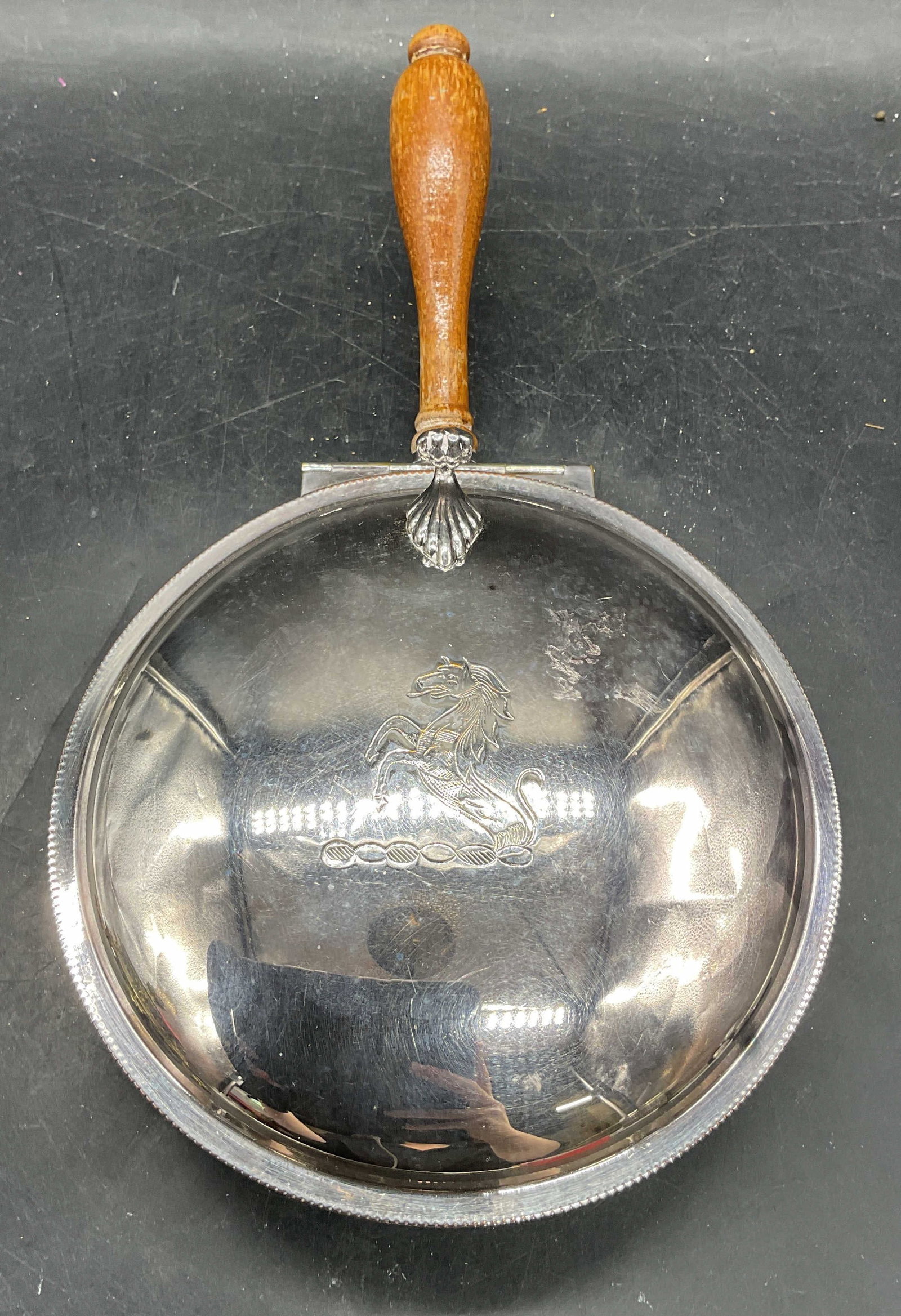 Vintage Silver Plated Horse Silent Butler: Vintage silver plated silent butler crumb catcher with wood handle. Chased horse motif. Measures approx. 6 x 10 x 2.5 inches. Some scratching and patina. Silver plated silent butler, silver plated cru