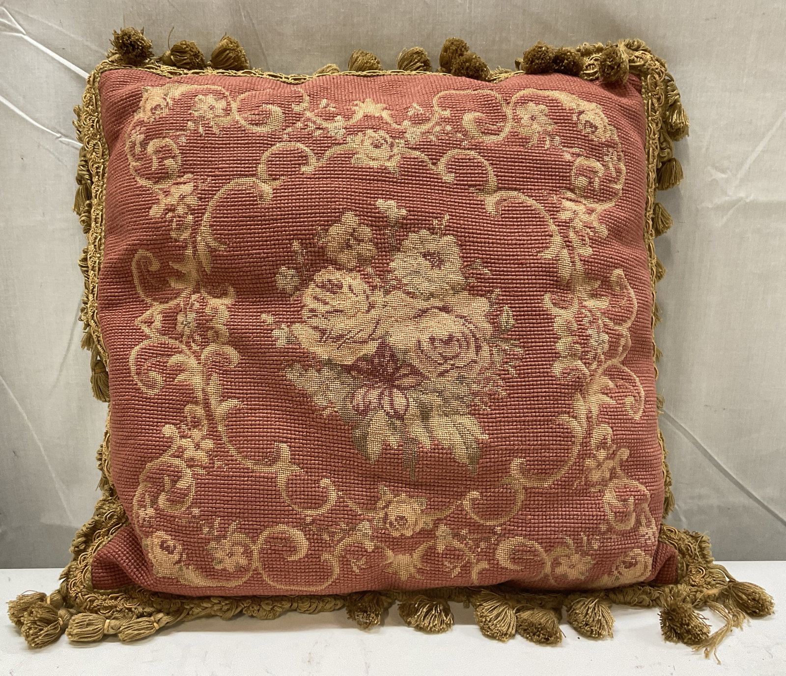 VTG Wool Needlepoint Rose Design Fringed Pillow: Vintage Wool Needlepoint Fringed Throw Pillow. Pink with Decorative Rose Design With Border. Light Brown Fringe. Condition Consistent With Exposure. Measures app 16.5in H x 15in W. Vintage, Wool,