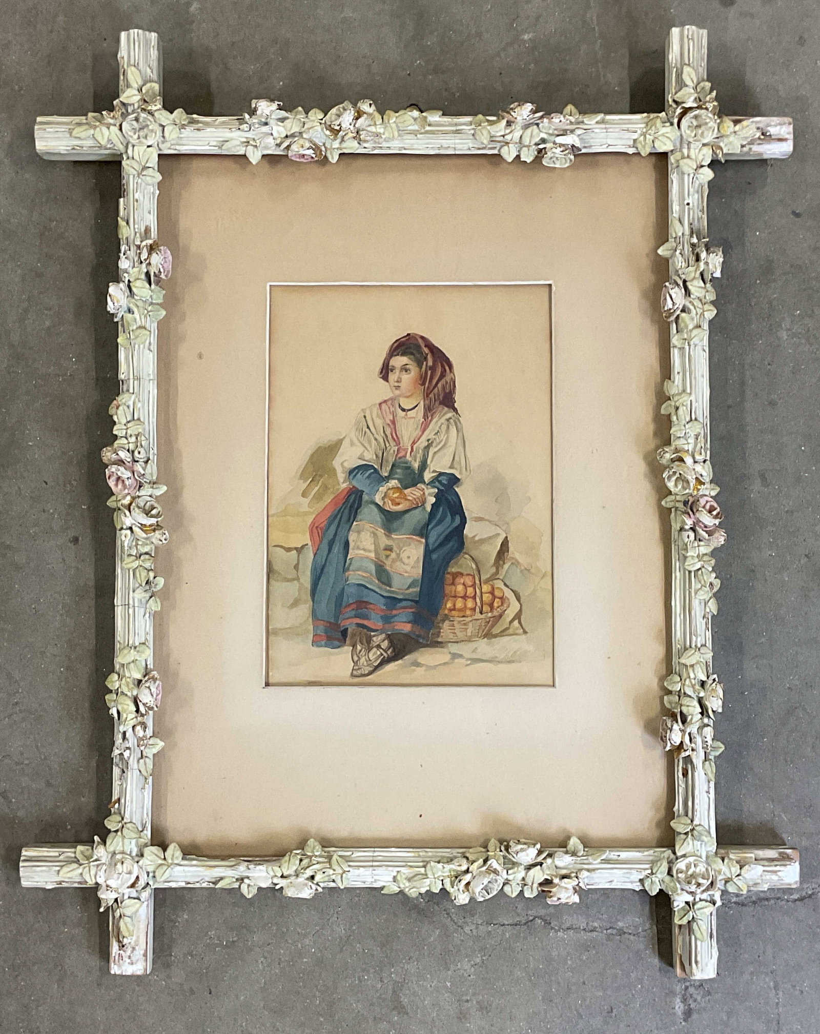 Framed Woman with Fruit Watercolor Painting: Framed and matted watercolor painting. Italian style peasant woman with basket of fruit. Ornate decorative floral wood frame. Not examined out of frame. Frame measures approx. 28.5 x 23.25 inches. Som