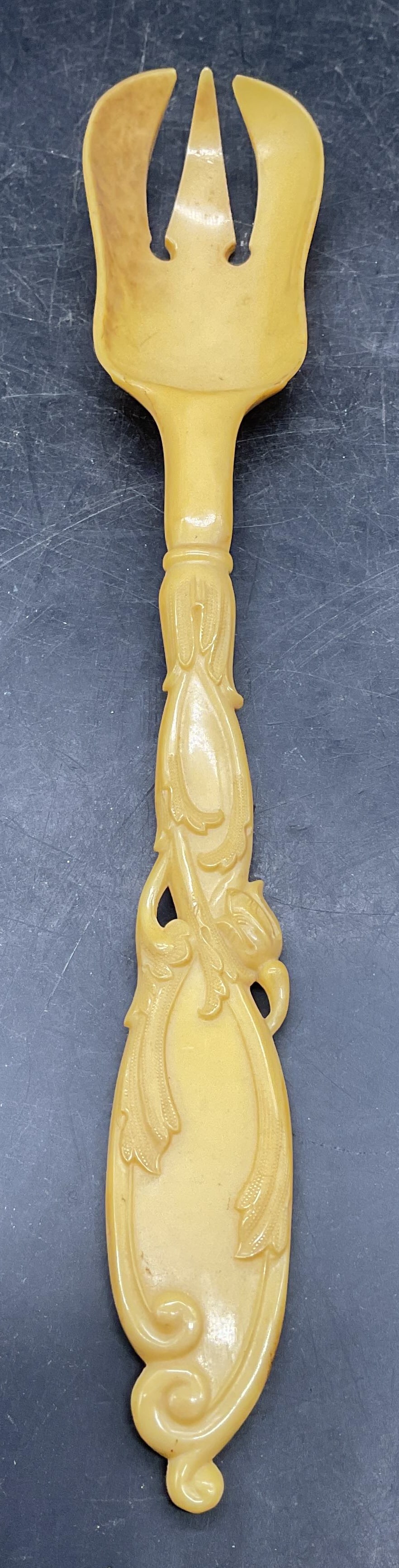 Victorian Style Faux Bone Serving Fork: Victorian style faux bone serving fork with ornate handle. Possibly cellulose or other manmade material. Measures approx. 10.25 inches long. Some scratching and discoloration. Faux bone fork,
