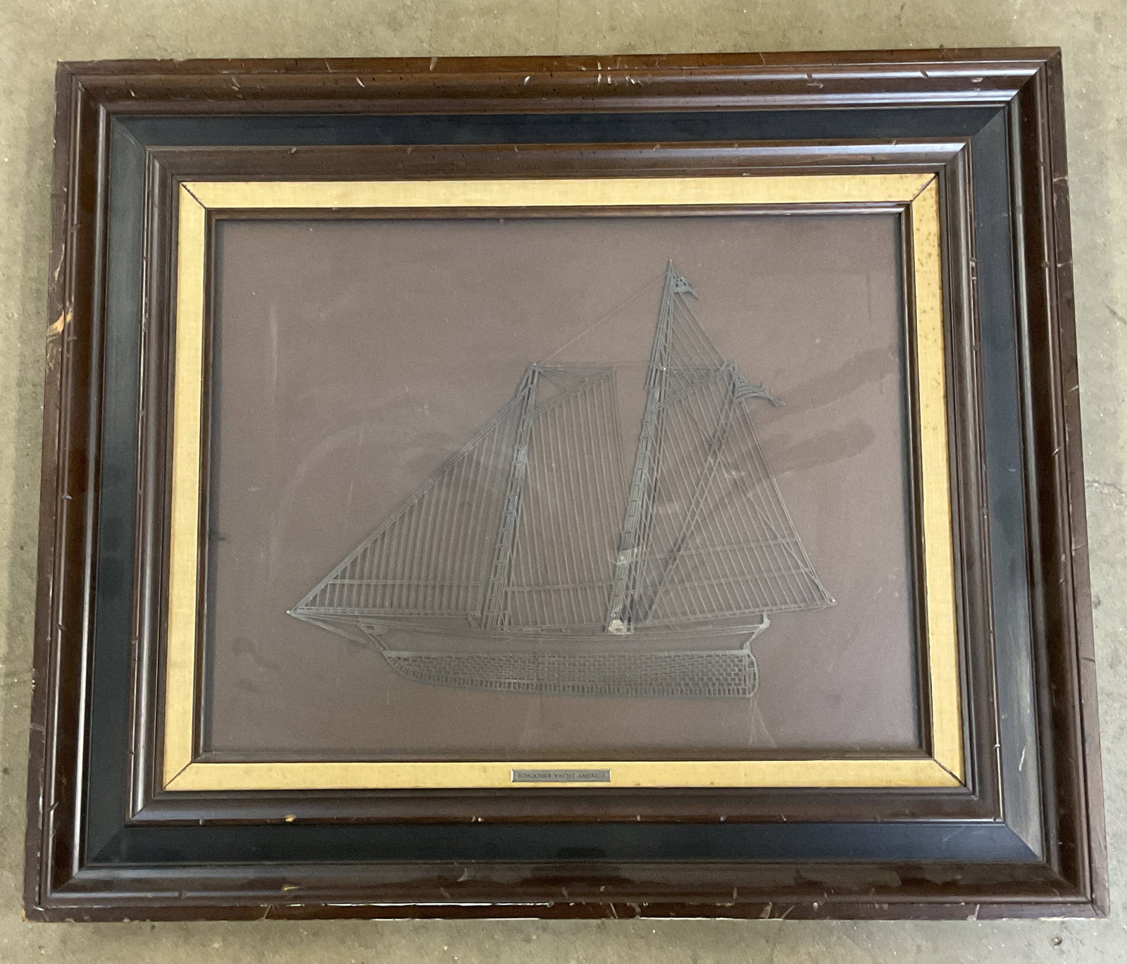 1976 Franklin Mint Sterling Silver Schooner Yacht: Framed 1976 Franklin Mint sterling silver ship silhouette. Schooner Yacht America. Wood frame. Not examined out of frame. Frame measures approx. 21.25 x 25.25 inches. Wear including scratching.