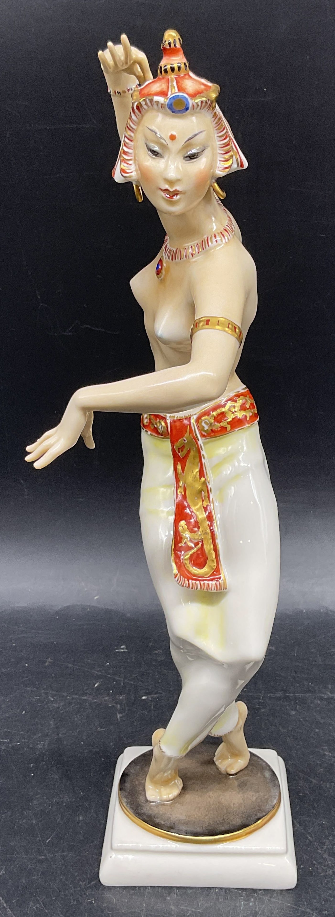 HUTSCHENREUTHER Werner Dancer Figurine Germany: Vintage HUTSCHENREUTHER porcelain figurine. Asian dancer. Designed by Carl Werner. Hand painted. Made in Germany. Measures approx. 3 x 4.75 x 11.25 inches. Some scratching. HUTSCHENREUTHER figurine, C