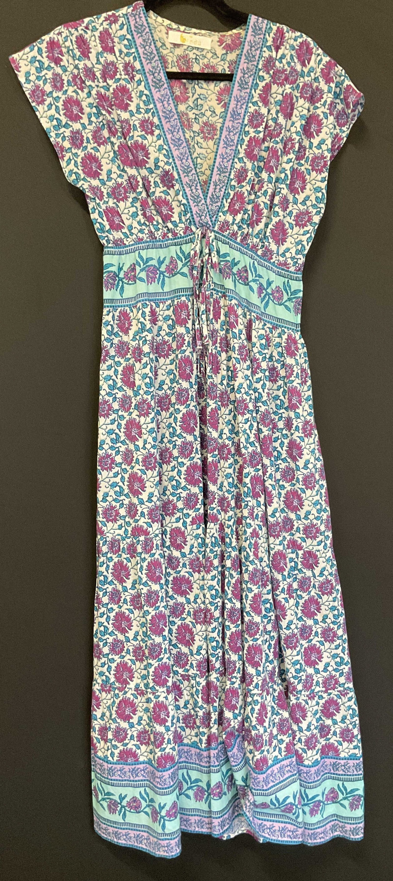 Bindu Blue & Purple Floral Maxi Dress India: Bindu blue and purple floral maxi dress. Size XS. 100% cotton. Made in India. Front pockets. Blue, purple, and white floral pattern. Ribbon accent. Wear consistent with exposure. Dress, maxi dress,