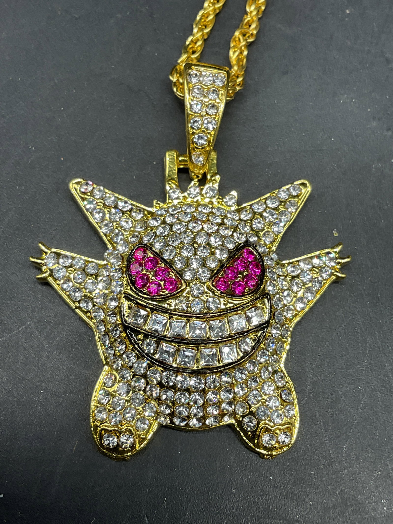 Gold Tone Crystal Gengar Pokemon Necklace: Gold tone Pokemon Gengar crystal pendant necklace. Drop length 10.5 inches. Some scratching. Jewelry, estate jewelry, costume jewelry, cocktail jewelry, fashion jewelry, accessories, fashion