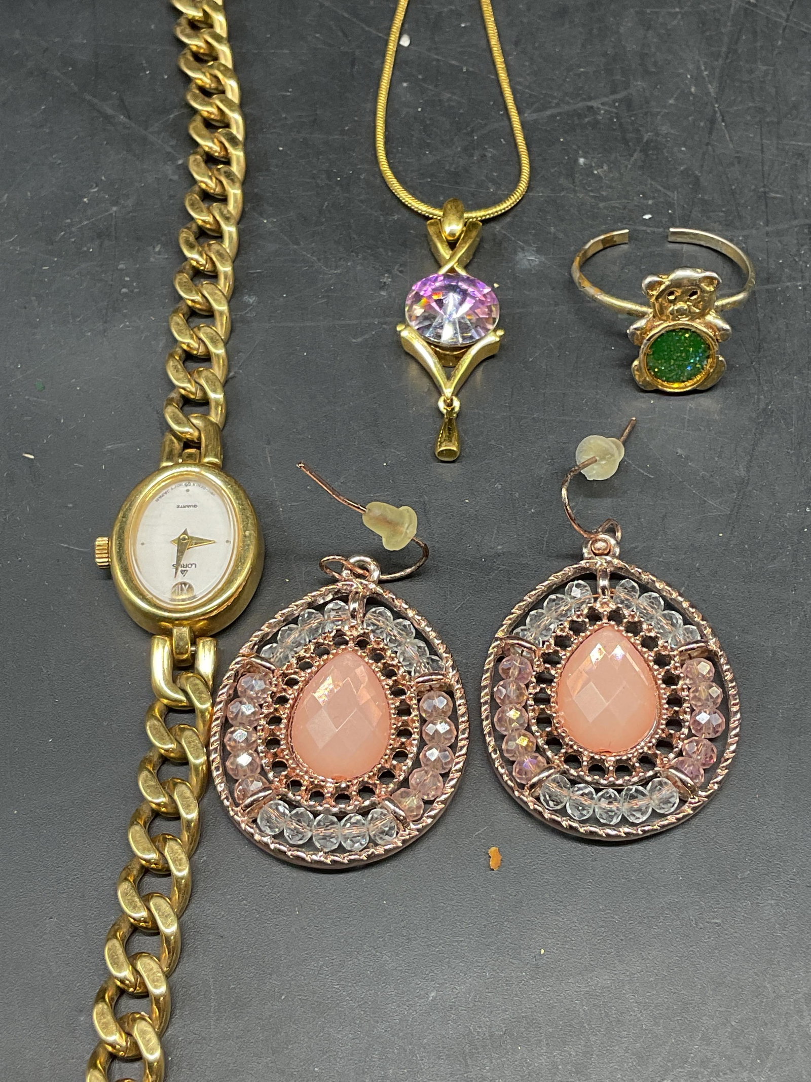 Lot 4 Gold Tone Necklace, Watch, Earrings +: Lot of 4 jewelry pieces. Signed gold tone watch with chain band. Signed illegibly. Not tested. Measures approx. 7.5 inches long. gold tone Crystal pendant necklace. Drop length 9.5 inches. Chain