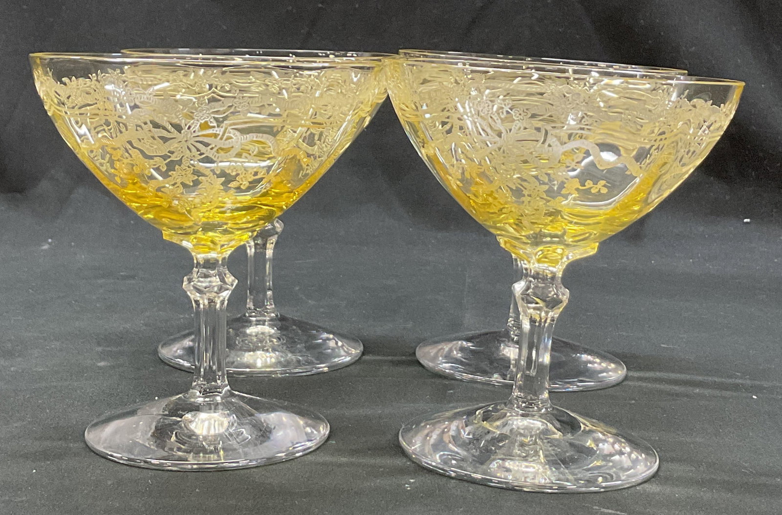 St4 Fostoria June Etched Yellow Champagne Glasses: Set of 4 Fostoria June etched yellow champagne glasses. Round base. Faceted stem. Wide rim. Yellow tinted. Etched floral and bow motifs, June pattern. Measures ht approx 4 inches diam approx 4