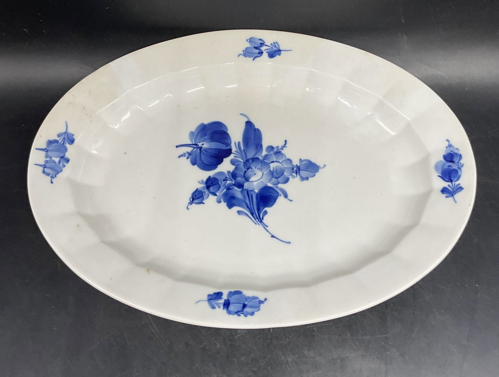 Royal Copenhagen Blue & White Porcelain Platter: Royal Copenhagen porcelain platter. Hand painted blue and white with floral motif. Made in Denmark. Measures approx. 13.25 x 9.75 inches. Some scratching. Royal Copenhagen platter, porcelain platter,