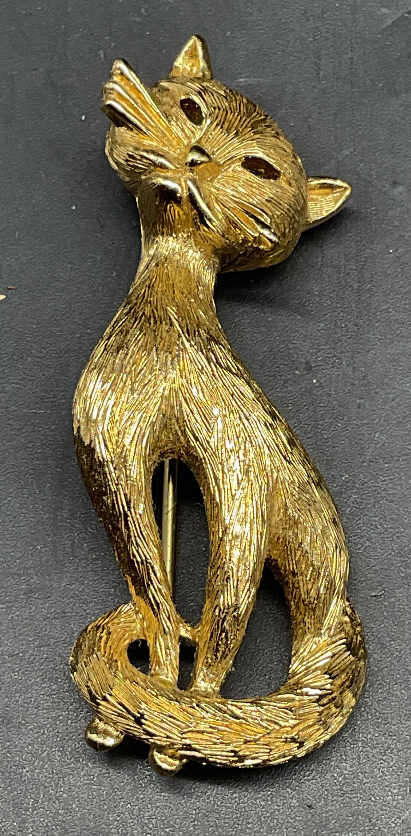 Vintage Monet Gold Tone Cat Brooch: Vintage Monet gold tone cat brooch. Measures approx. 2.25 x 1 inches. Some scratching. Jewelry, estate jewelry, costume jewelry, cocktail jewelry, fashion jewelry, accessories, fashion accessories, we