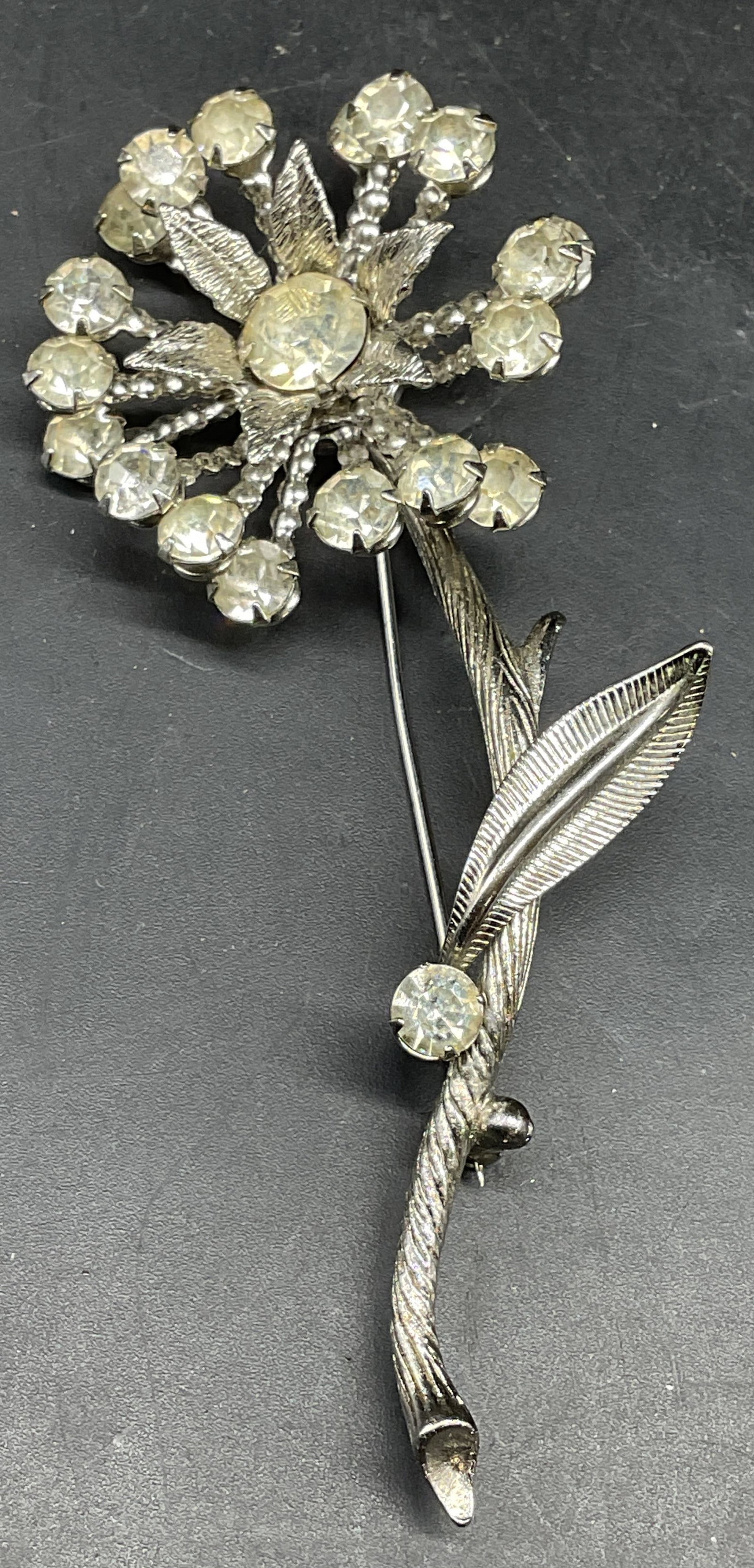 Vintage Silver Tone Crystal Flower Brooch 3.75 In: Vintage silver tone Crystal flower brooch. Measures approx. 3.75 x 1.5 inches. Some scratching. Jewelry, estate jewelry, costume jewelry, cocktail jewelry, fashion jewelry, accessories, fashion access