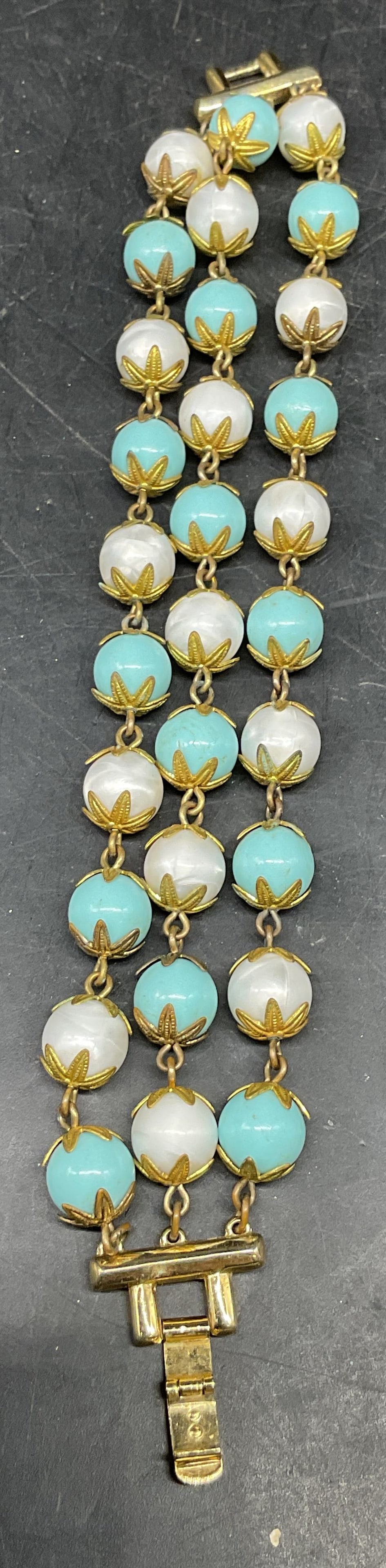 Vintage Trifari Blue & White Beaded Bracelet: Vintage Trifari gold tone blue and white beaded three strand bracelet. Measures approx. 7.25 inches long. Some scratching. Jewelry, estate jewelry, costume jewelry, cocktail jewelry, fashion jewelry, 