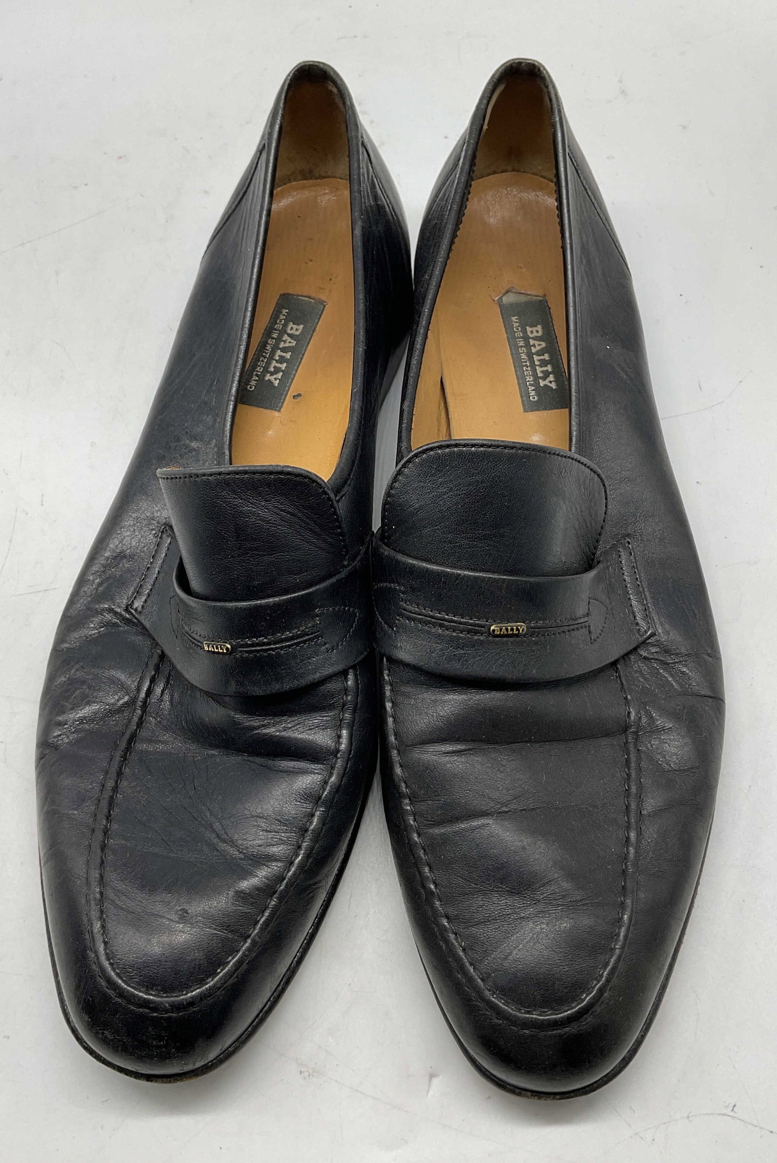 Bally Black Leather Loafers Switzerland: Bally black leather loafers. Made in Switzerland. Size 10. Heeled shoe. Wear consistent with exposure. Loafers, shoes, Bally, wearables, outerwear, fashion, accessories. 4CS