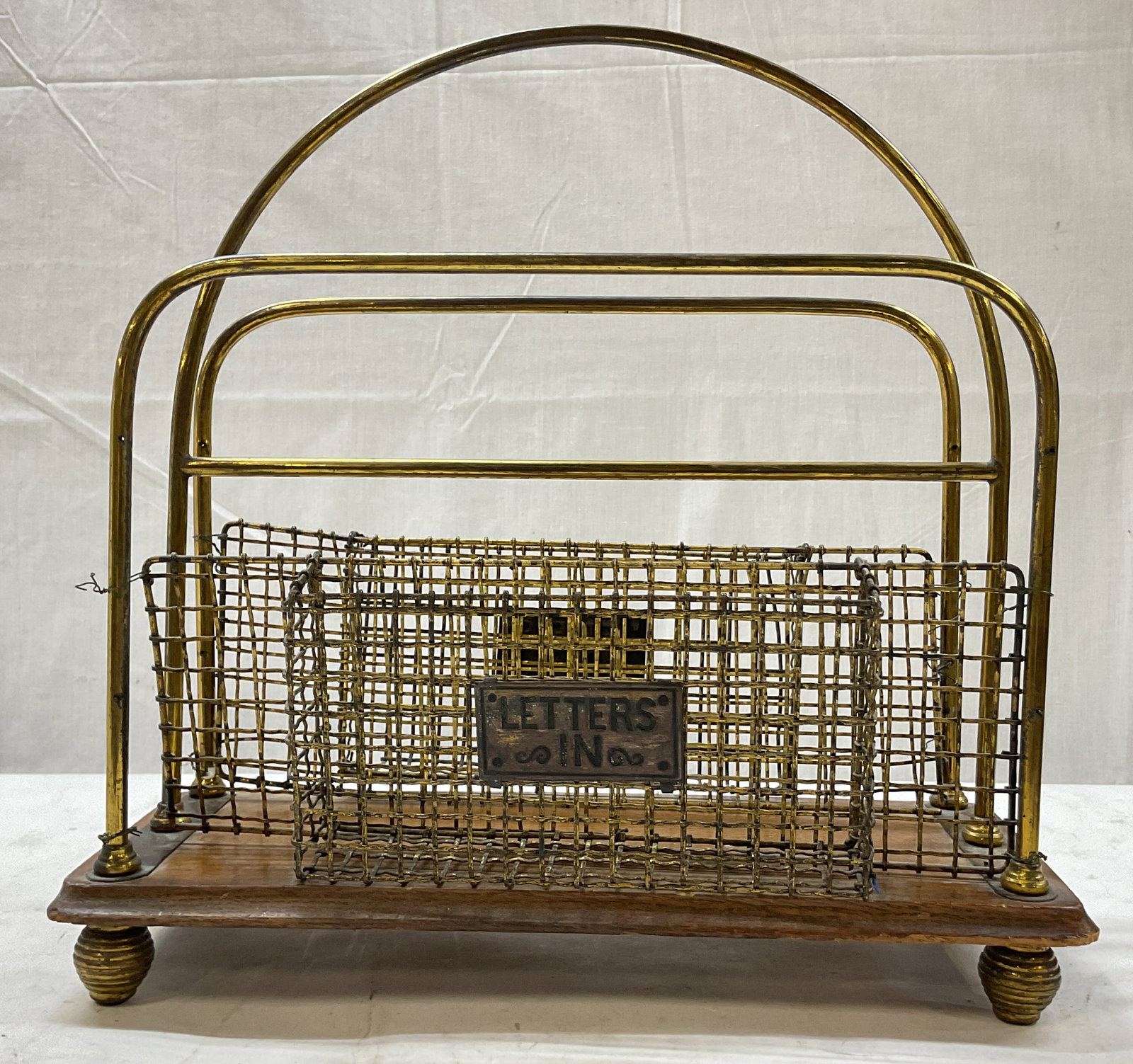 Antique Wood & Brass Mesh Footed Letter Rack: Antique wood and brass mesh footed letter rack. Rectangular wooden base with four brass feet. Brass wire mesh frame. Handle on top. One side reads Letters Out and the other reads Letters In. Measures