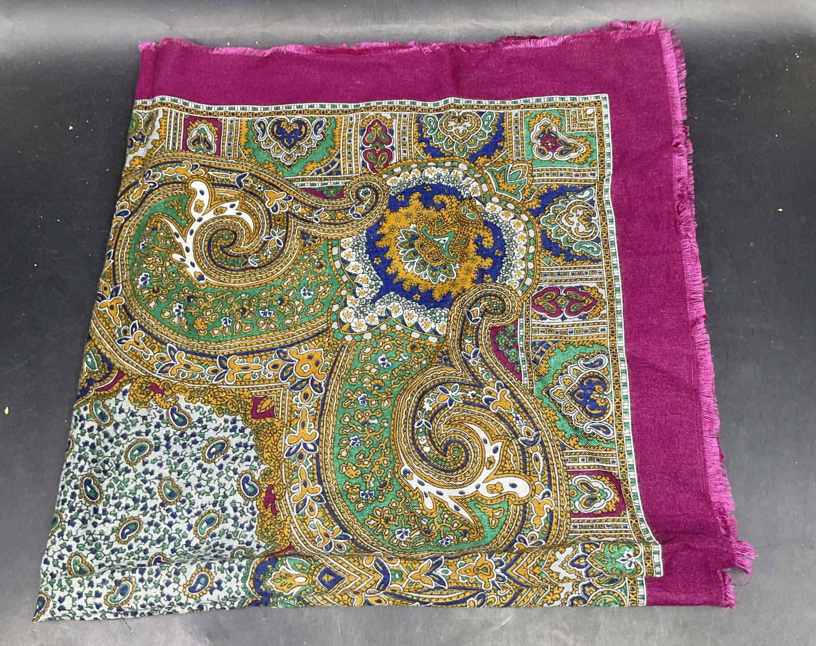 Purple & Green Paisley Print Wool Scarf: Purple and green paisley print scarf. Feels like wool, possibly cotton. Measures approx. 28 x 28 inches. Some wear consistent with exposure. Paisley scarf, wool scarf, purple scarf, green scarf, acces
