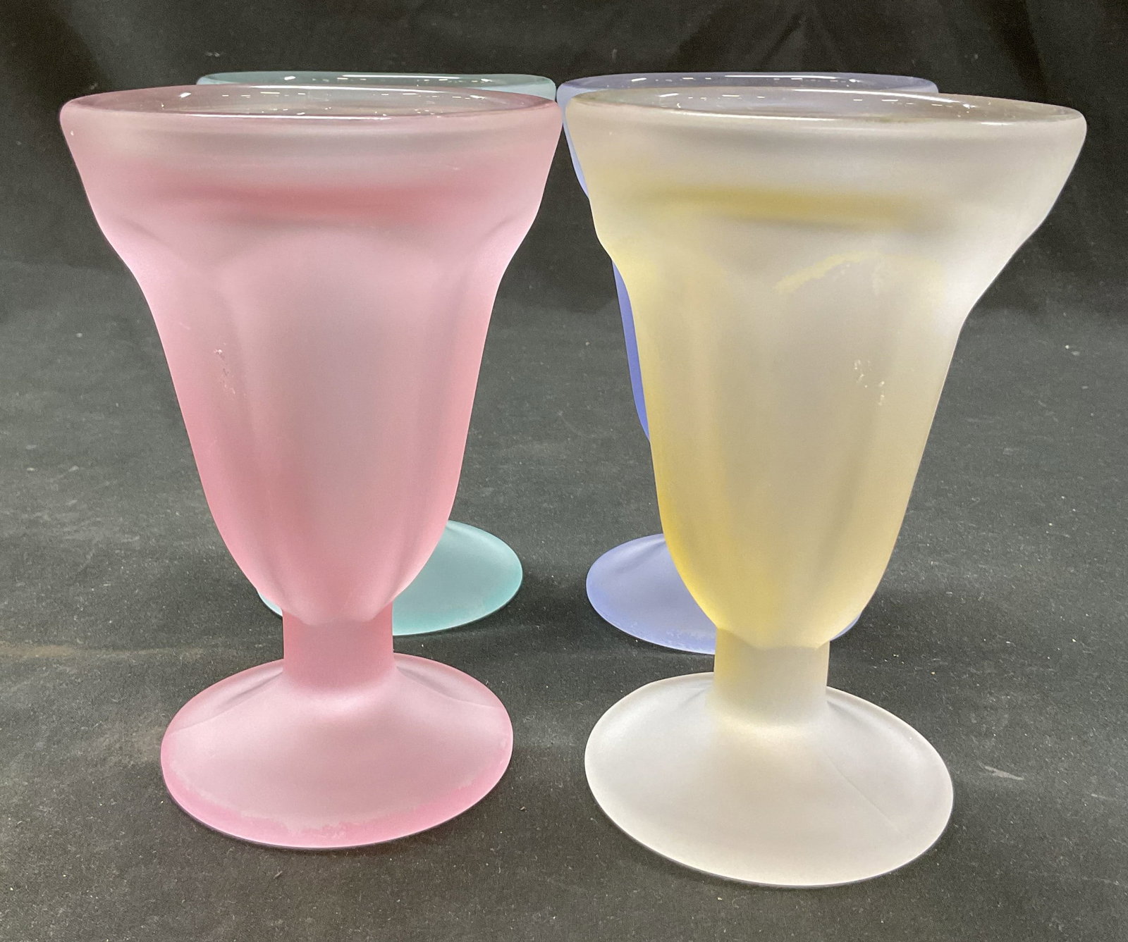 Lot 4 Libbey KaDinks Frosted Parfait Glasses: Lot of 4 Libbey KaDinks frosted parfait glasses. Round pedestal base. Wide rim and faceted body. Comes in blue, pink, purple, and yellow. Measures ht approx 6 inches diam approx 4 inches. Scratching.