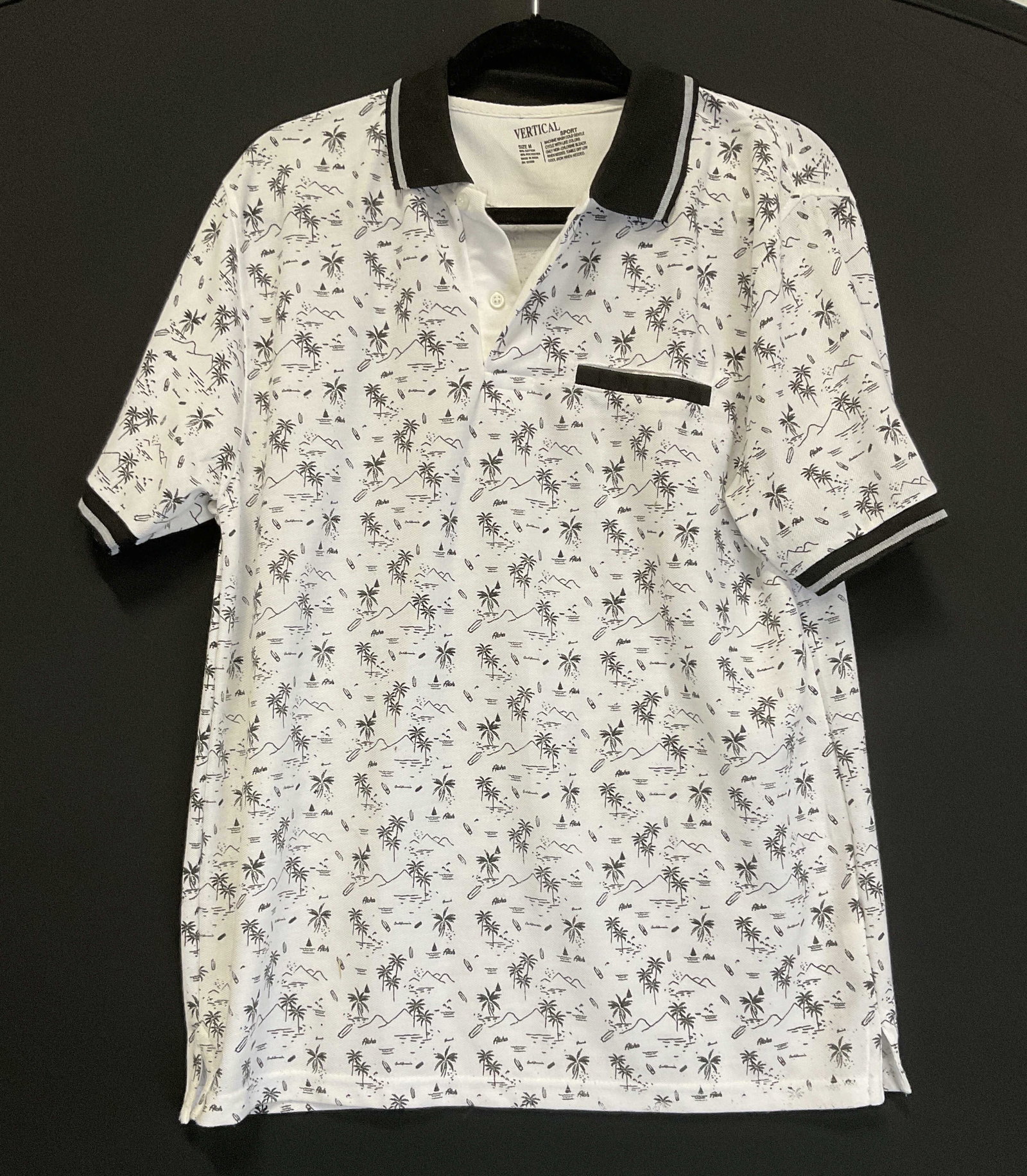 Vertical Sport White Hawaii Graphic Polo Shirt: Vertical Sport White Hawaii Graphic Polo Shirt. Features Black Graphics of Palm Trees, Shark Fins, Surfboards, Mountains, Water, and Words Aloha. Size M. Some Staining. Vertical Sport, Polo Shirt,