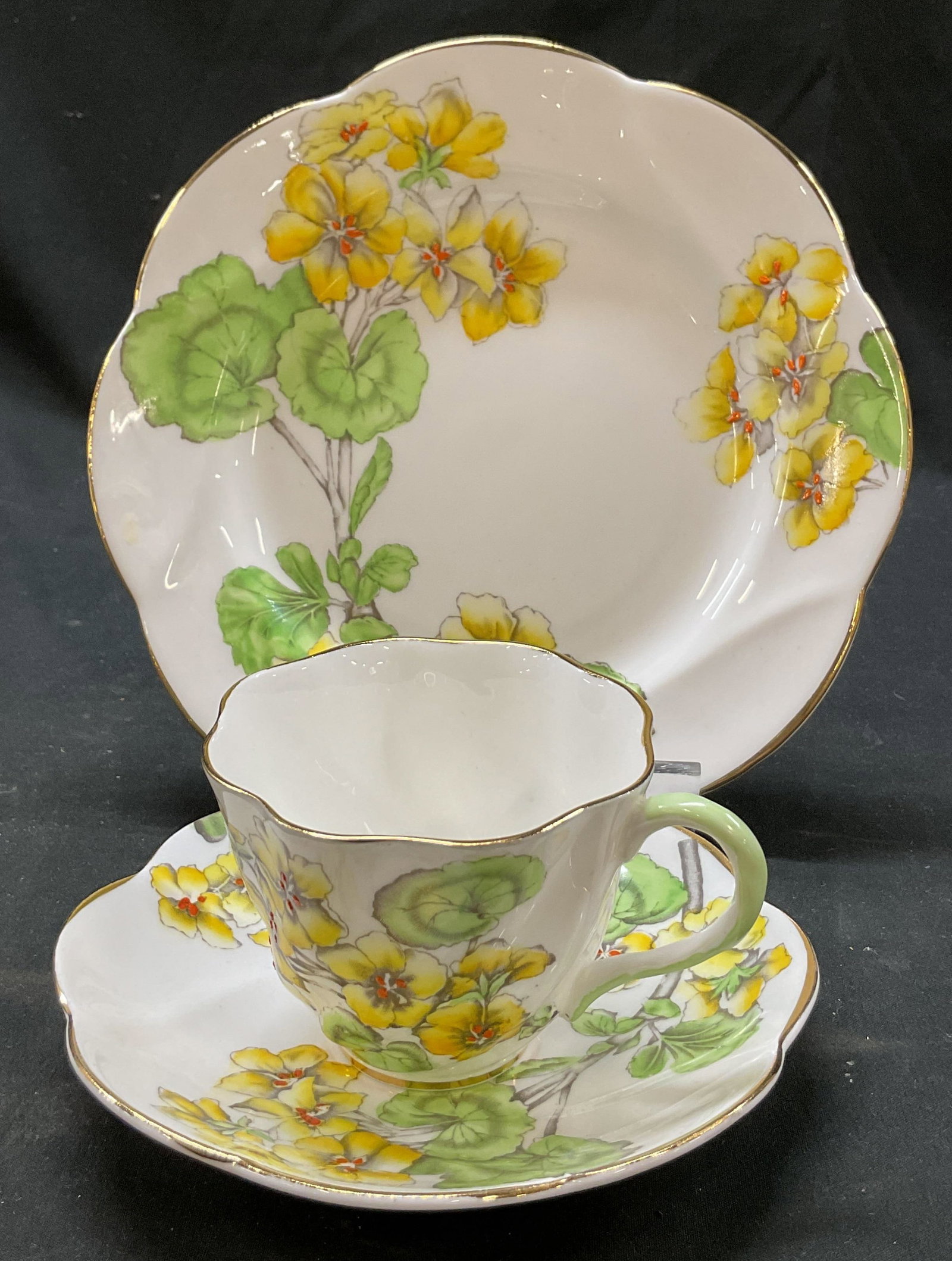 Set 3 Salisbury Teacup, Saucer, Plate England: Set of 3 items. Salisbury Geranium bone china teacup, saucer, and plate. Marked on underside, reads Geranium Salisbury Fine Bone China Made In England. Scalloped gilt edges. Green and yellow floral