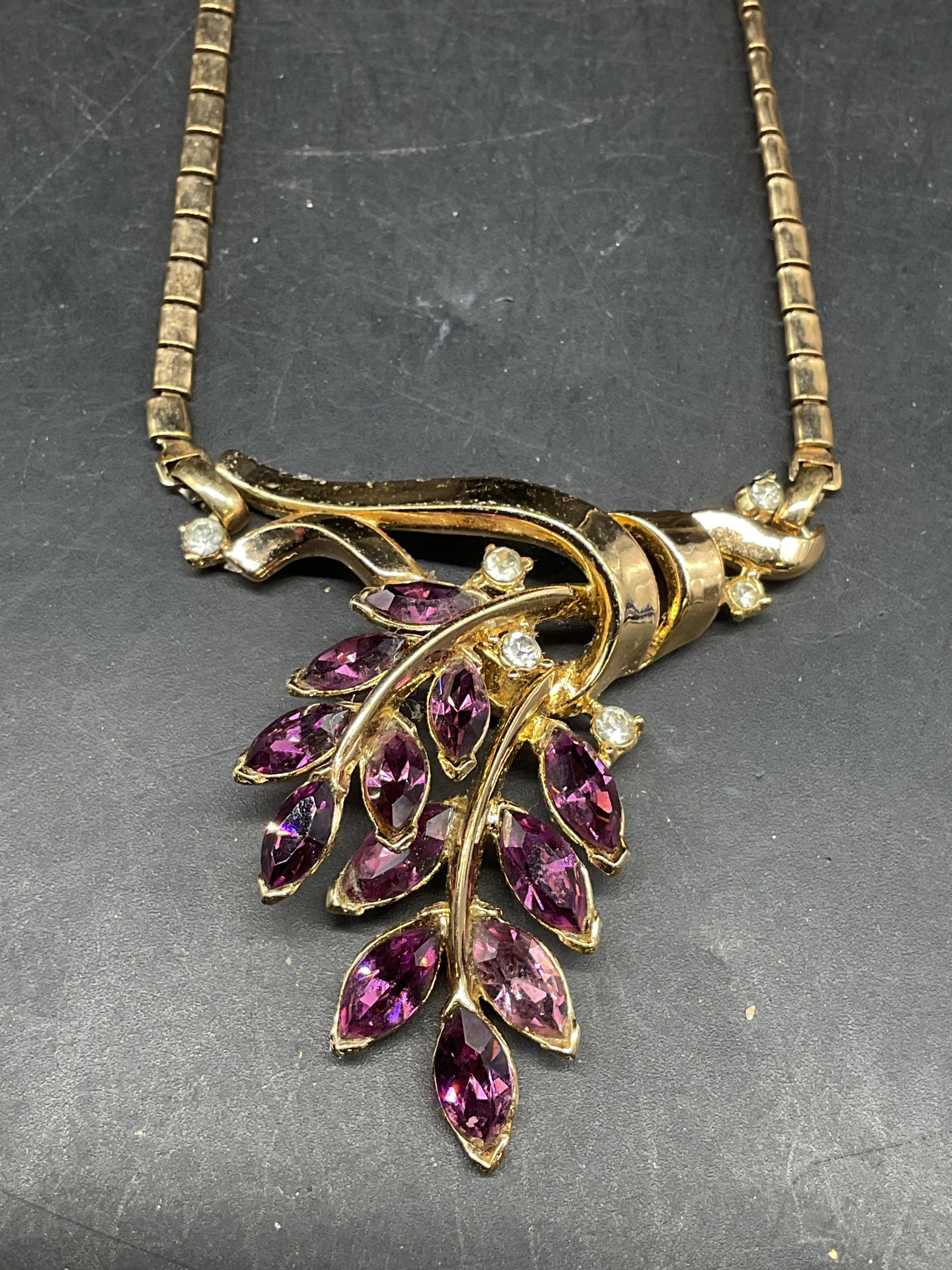 Vintage Trifari Gold Tone Flower Pendant Necklace: Vintage Trifari gold tone purple crystal flower pendant necklace. Drop length 9 inches. Some scratching. Jewelry, estate jewelry, costume jewelry, cocktail jewelry, fashion jewelry, accessories,