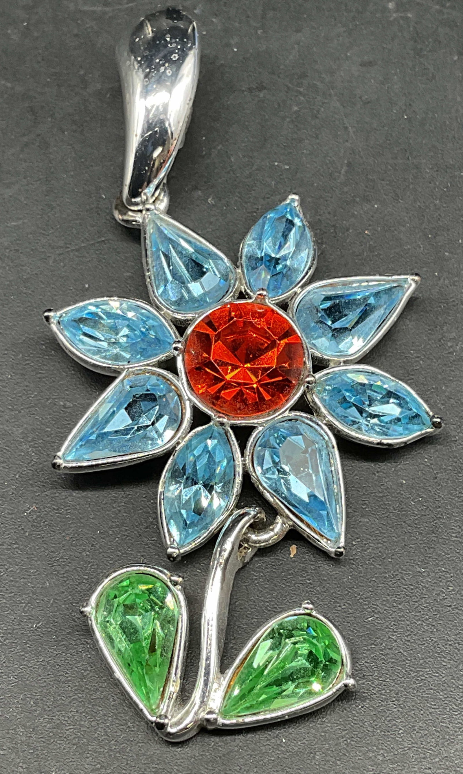 Vintage Napier Blue Crystal Flower Pendant: Vintage Napier silver tone blue, red, and green crystal flower pendant. Measures approx. 2 x 1.25 inches. Some scratching. Jewelry, estate jewelry, costume jewelry, cocktail jewelry, fashion jewelry,