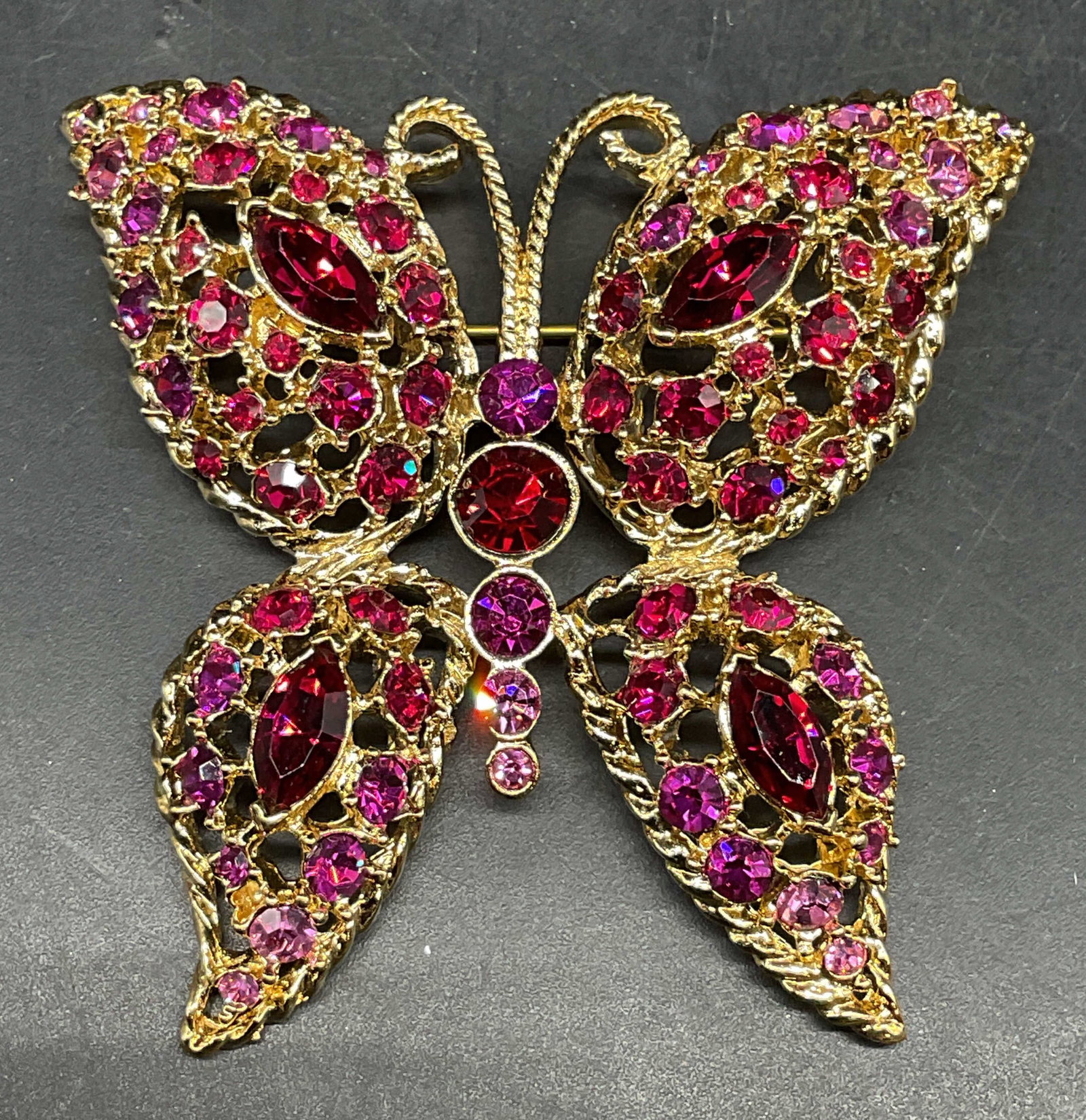 Napier Gold Tone Pink Crystal Butterfly Brooch: Vintage Napier gold tone pink and red crystal butterfly brooch. Measures approx. 2.25 x 2.5 inches. Some scratching. Jewelry, estate jewelry, costume jewelry, cocktail jewelry, fashion jewelry,
