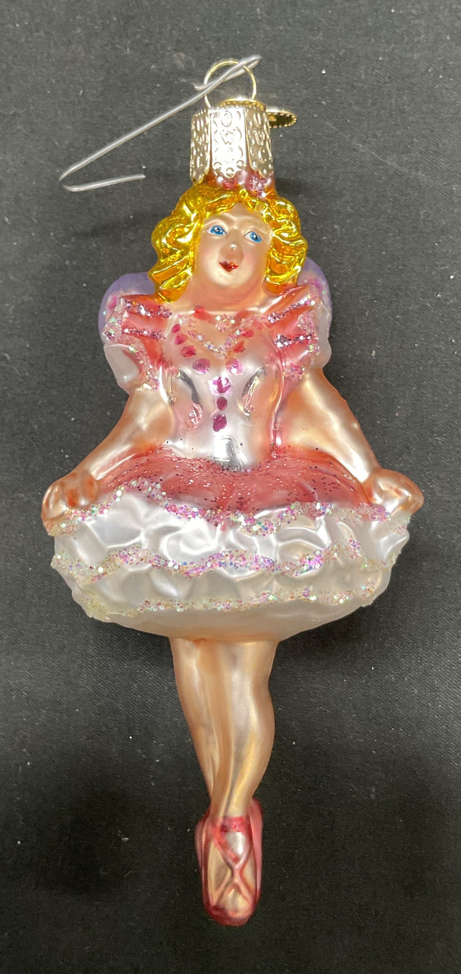 Old World Christmas Sugar Plum Fairy Ornament: Old World Christmas Sugar Plum Fairy ornament. Blown glass. Hand painted pink tutu and wings with glitter accents. Measures approx 5 inches in length. Surface wear consistent with exposure. Ornament,