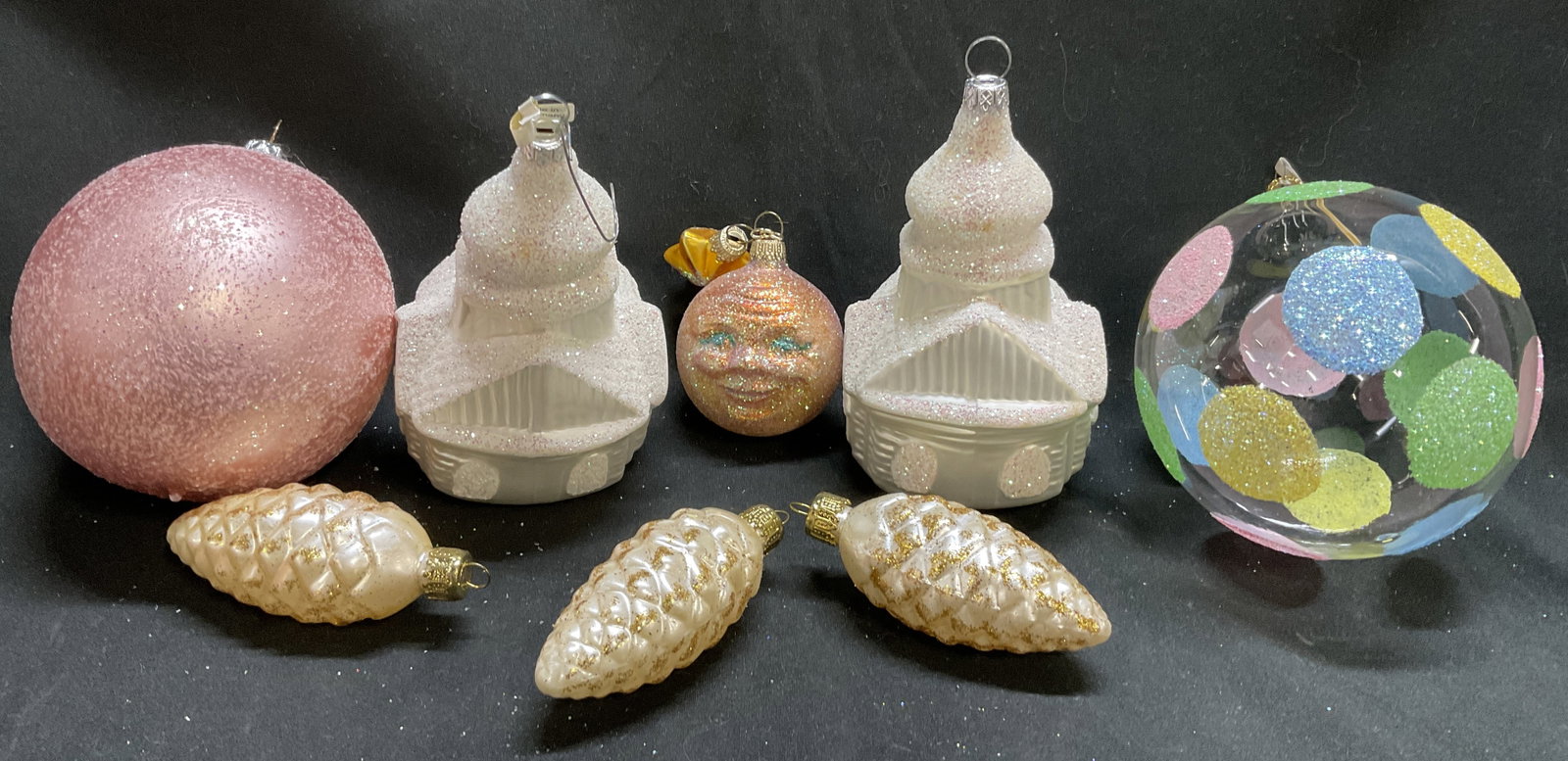 Lt8 VTG-Style Glittery Pastel Ornaments GERMANY+: 8 Vintage-Style Glittery Pastel Glass Ornaments. Includes 3 White Pinecones, 2 Snow-Covered Churches Made in Germany, A Moon Face with Star Accent, A Pink Glittery Ball, And A Glass Ball with Pastel