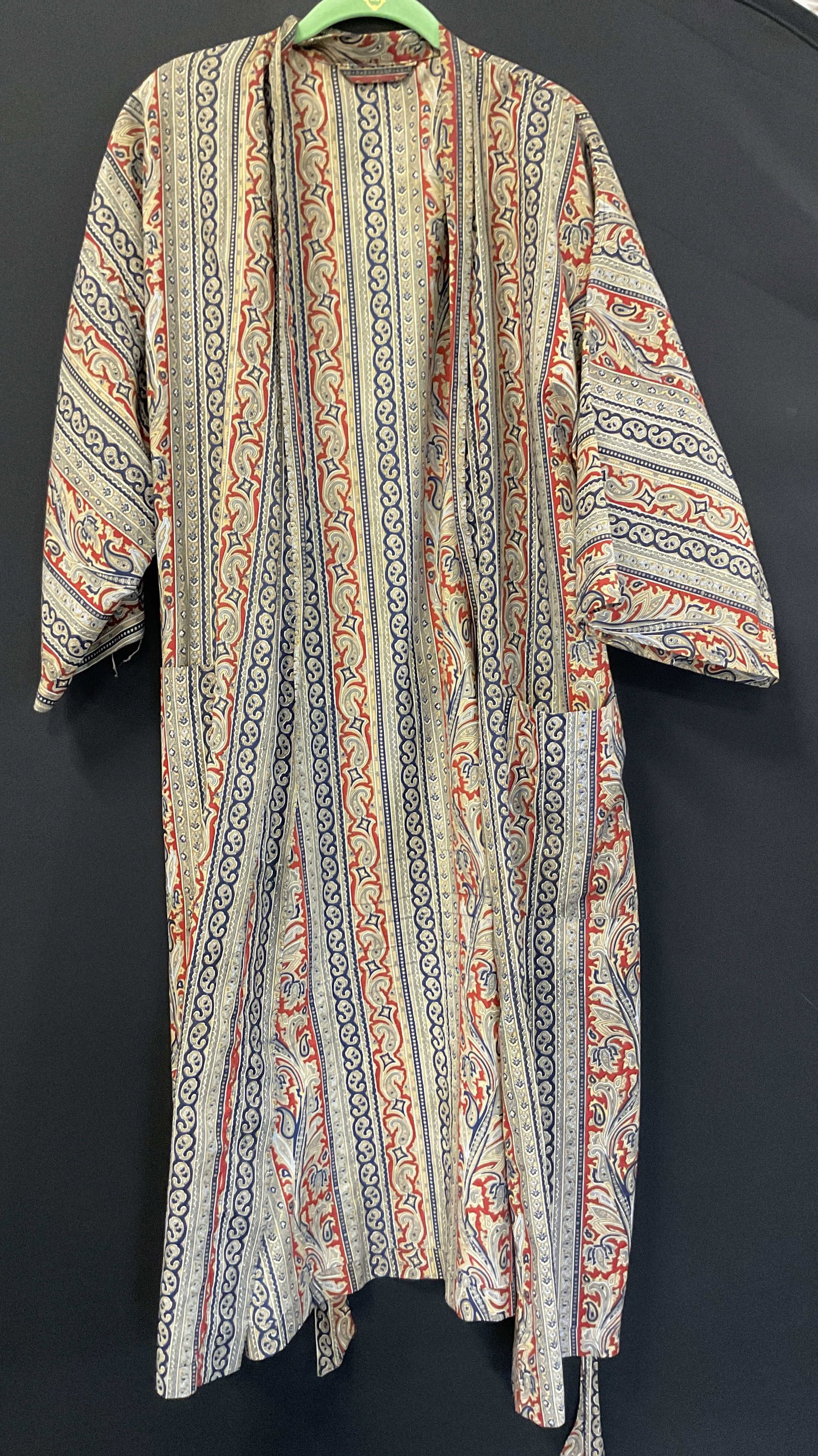 Vintage Paisley Pattern Robe: Vintage paisley pattern robe. Red, blue, white, more. Pockets and tie. Measures approx 18 inches across chest. Wear consistent with exposure. Robe, wearables, clothing, fashion, accessories. 4H