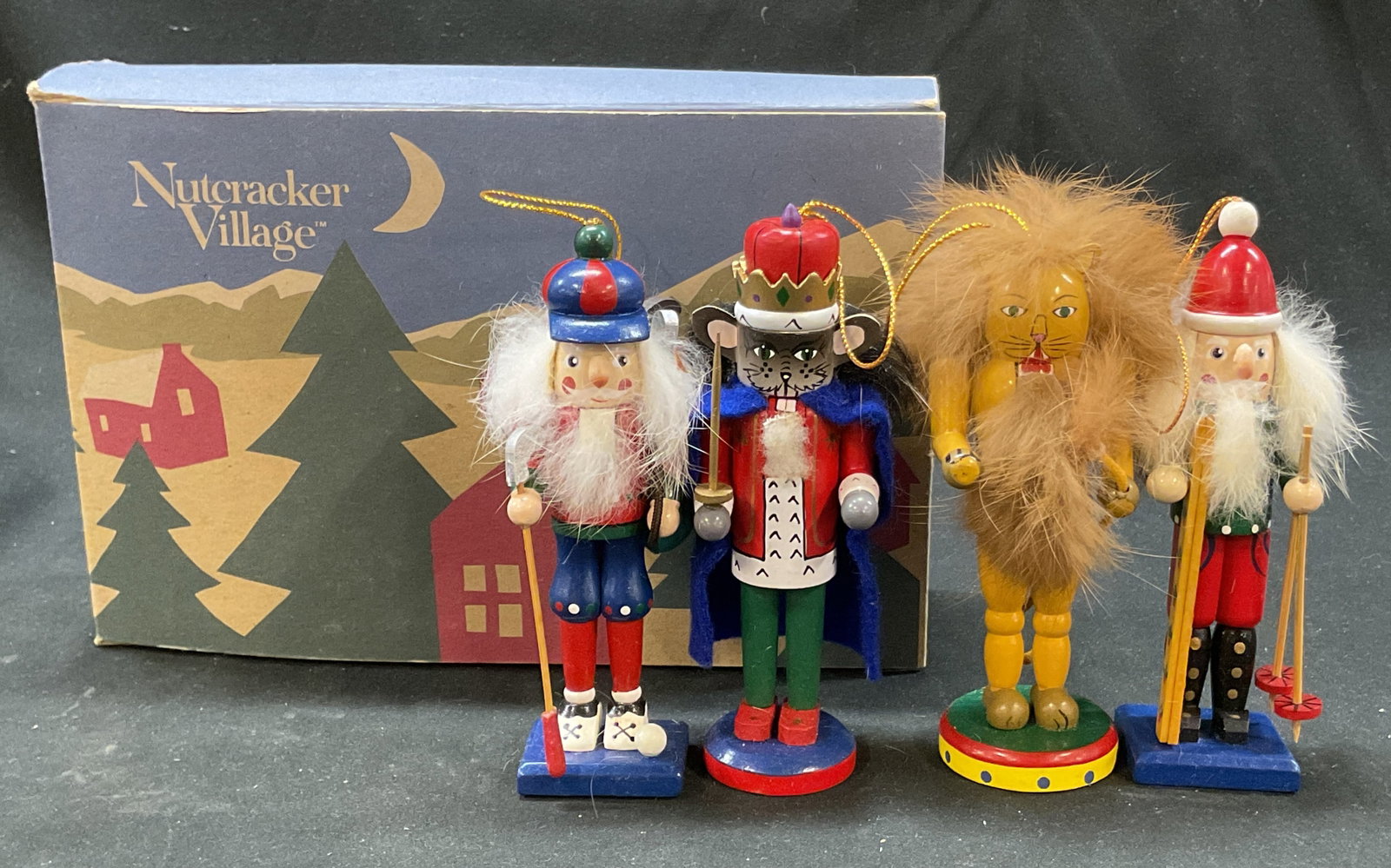 Set 4 Nutcracker Village Nutcracker Ornaments: Set of 4 Nutcracker Village hand crafted wooden nutcracker ornaments. Comes in original box. Copyright 1994 May Department Stores Company. Figures and animals. Hand painted in varying colors.