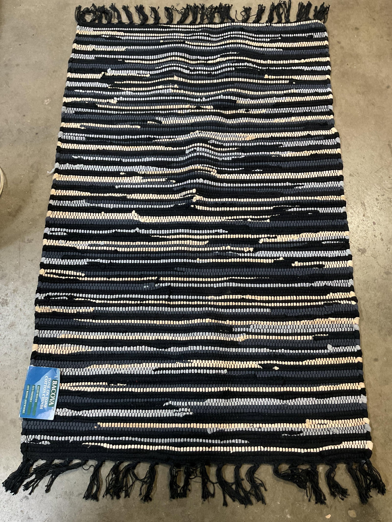 Bacova Hand Woven Rag Rug India NWT: New with tag. Bacova hand woven rag rug. Made in India. 100% cotton. Black fringed trim. Black, blue, and white pattern. Measures 27 x 45 inches. Rag rug, rug, carpets, home decor, decor,