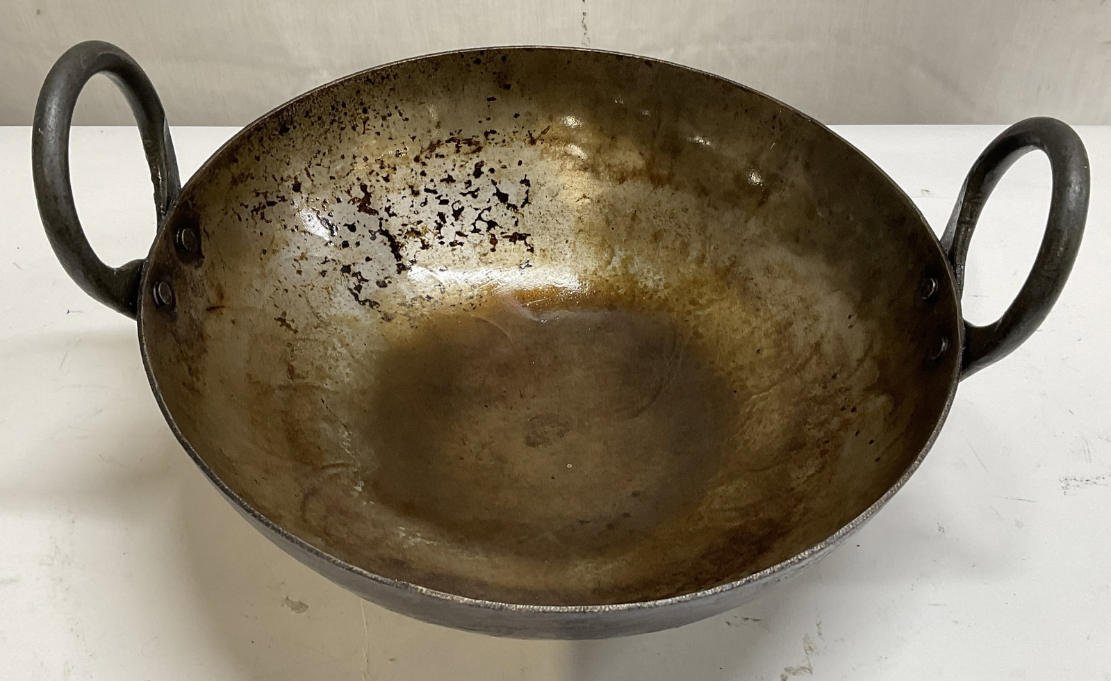 VINTAGE Handmade Iron Wok: Vintage Handmade Iron Wok With Twin Riveted Handles. Scratching, Dark Patina, and Residue Present. Measures app 5in H x 10.25in Diam. Vintage, Handmade, Wok, Frying Pan, Cooking, Kitchen Accessories,
