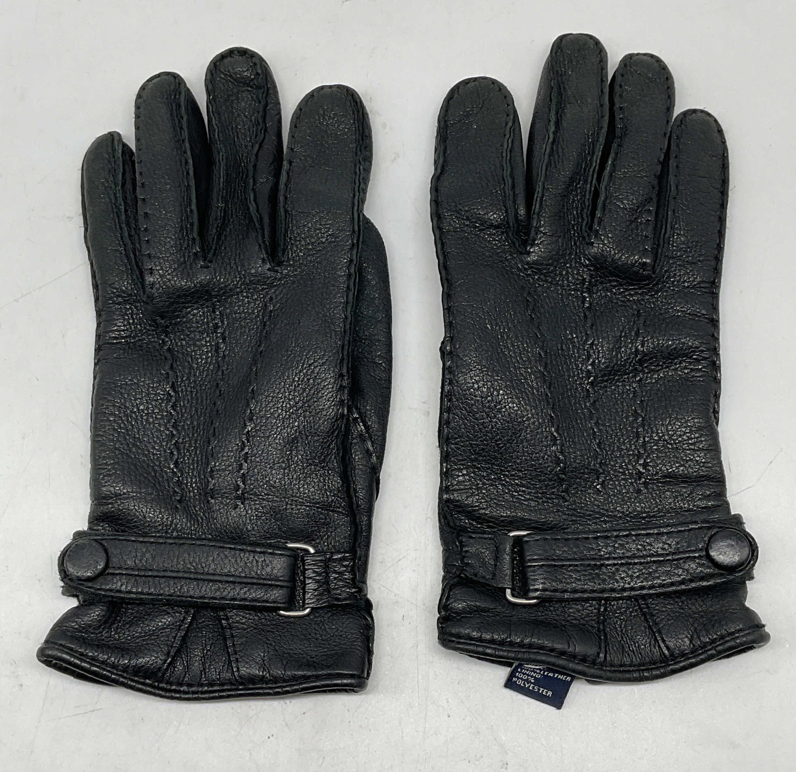 Black Leather Button Strap Gloves: Black leather gloves with a button strap. Size large. Polyester lining. Some wear to leather and fading. Leather gloves, black leather gloves, black gloves, accessories, fashion accessories, wearables