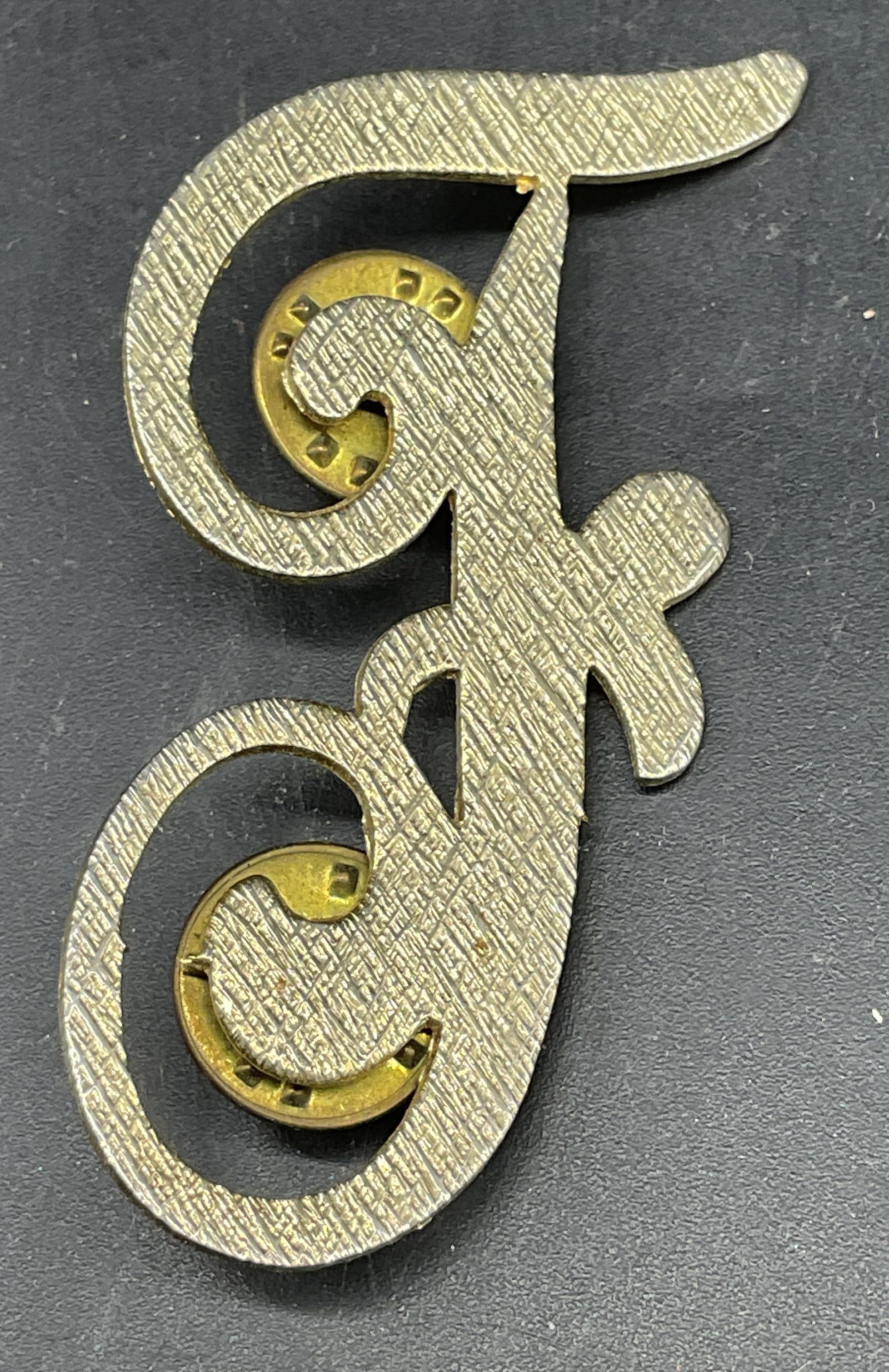 Vintage Brushed Gold Tone Letter F Pin: Vintage brushed gold tone letter F pin. Measures approx. 2.25 x 1.25 inches. Some scratching. Jewelry, estate jewelry, costume jewelry, cocktail jewelry, fashion jewelry, accessories, fashion accessor