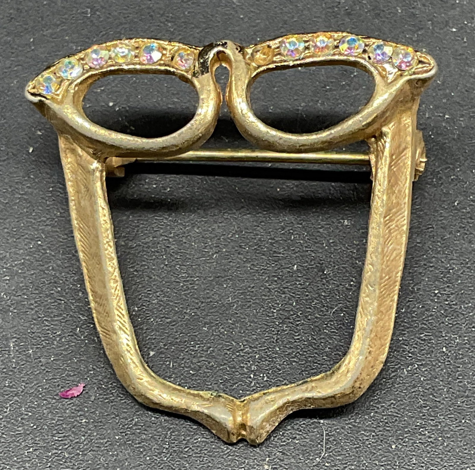 Vintage Gold Tone Crystal Eyeglasses Brooch: Vintage gold tone and crystal eyeglasses brooch. Measures approx. 1 x 1.25 inches. Some scratching. One crystal needs replacement. Jewelry, estate jewelry, costume jewelry, cocktail jewelry, fashion j