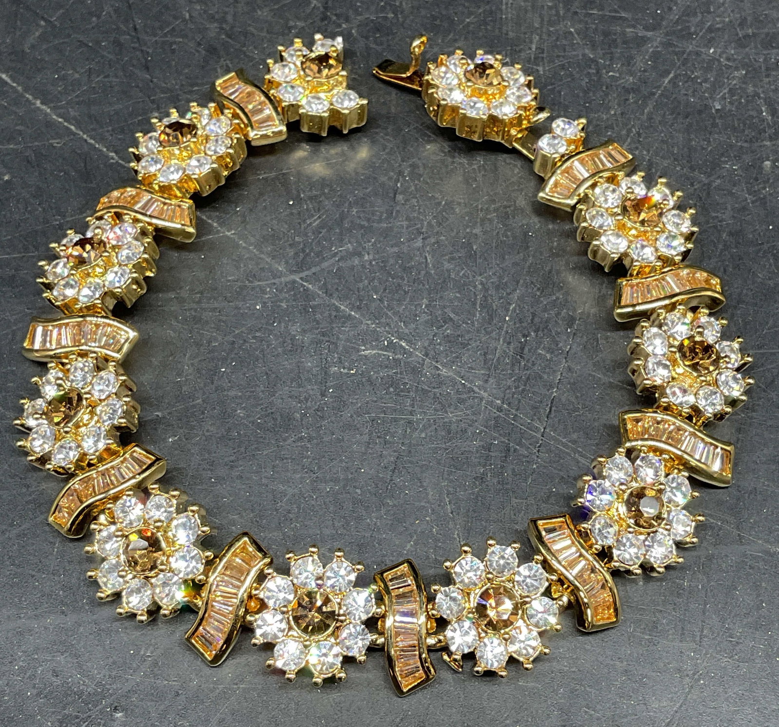 Camrose & Kross JBK Gold Plated Crystal Bracelet: Camrose and Kross Jaqueline Bouvier Kennedy gold plated bracelet with flower panels and colorless and amber toned crystals. Marked JBK. measures approx. 8 inches long. Some scratching. Jewelry, estate