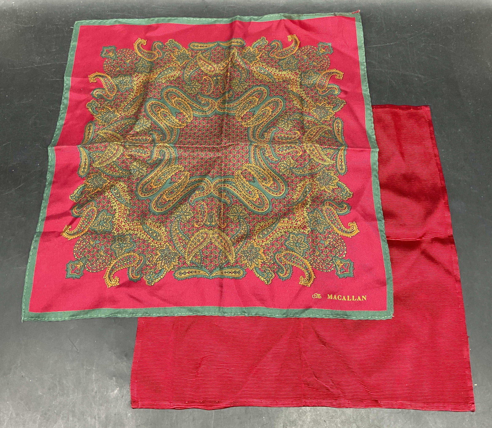 Lot 2 Macallan Red Paisley Silk Bandana +: Lot of 2 rd silk bandanas. Macallan paisley print bandana and solid red bandana. Larger measures approx. 13 x 13.5 inches. Some blemishes. Silk bandanas, red bandana, paisley bandana, accessories,